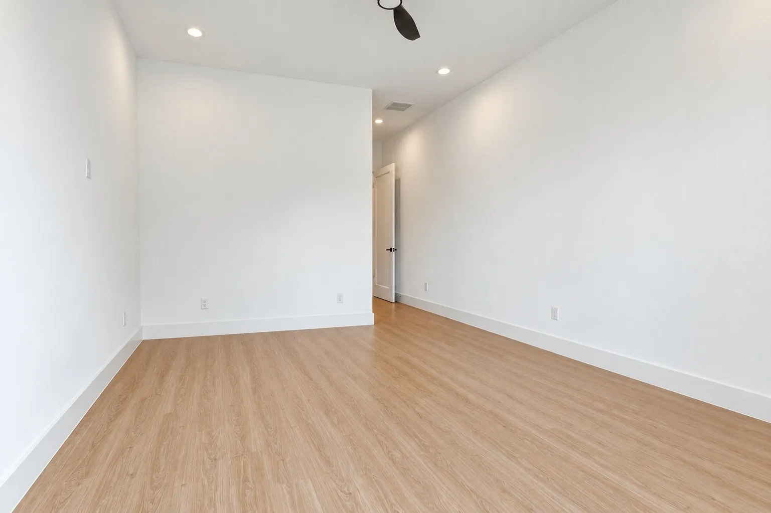Wood-finish flooring, recessed lighting, and a ceiling fan
