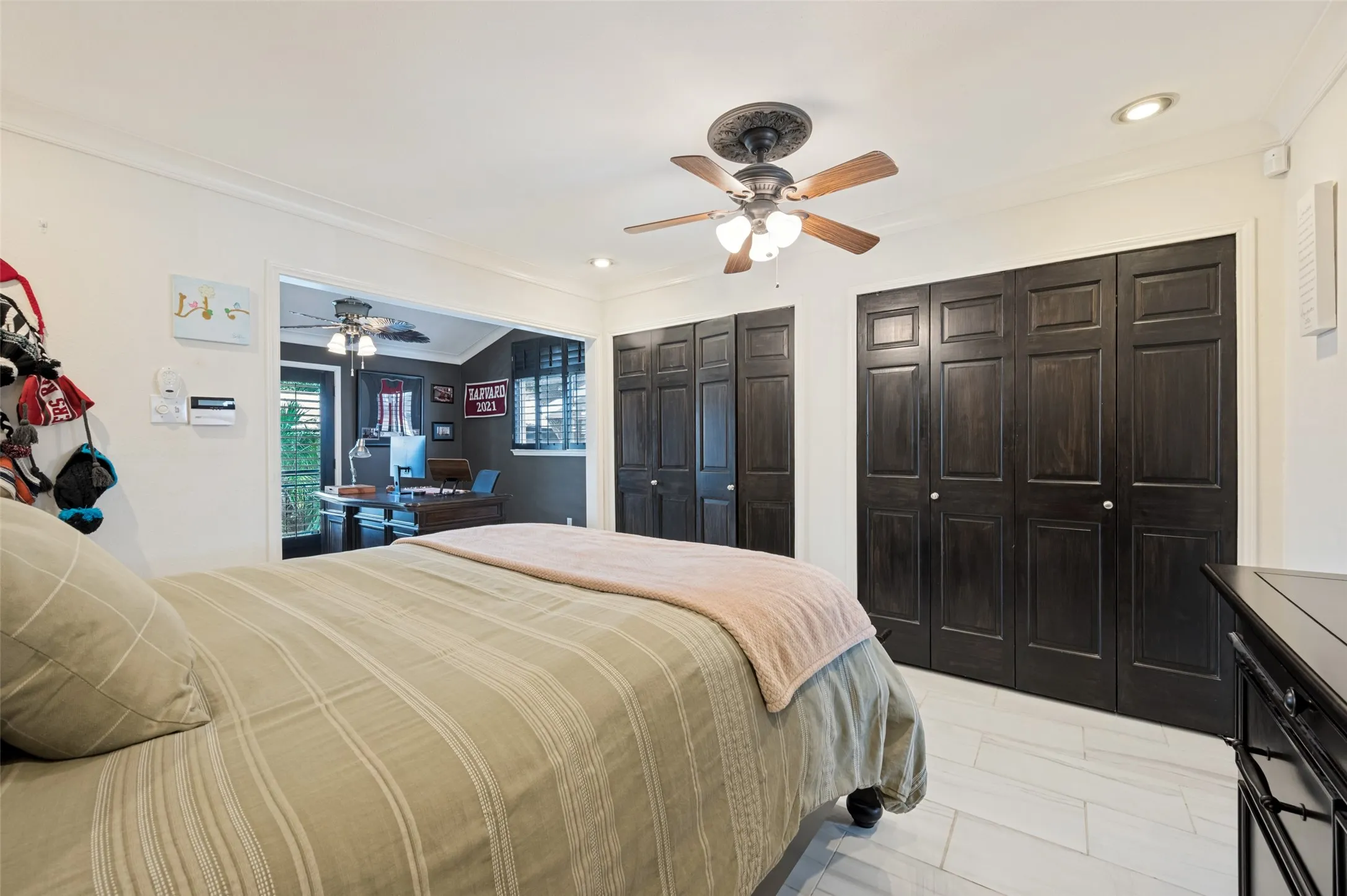 Recessed lighting, crown molding, and a ceiling fan with light fixture