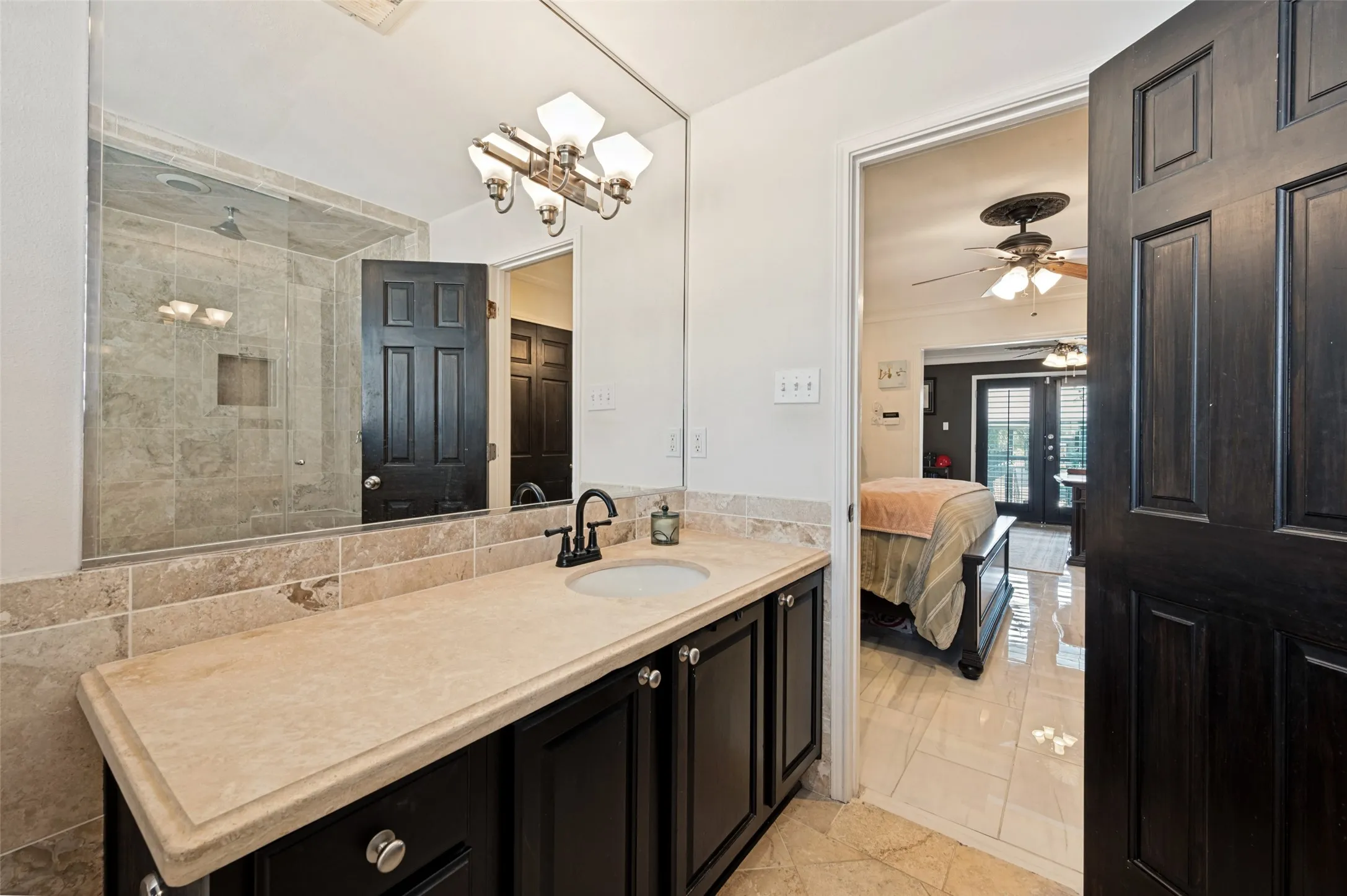 Vanity with a light-toned countertop, under-mount sink, and dark wood-finish cabinetry