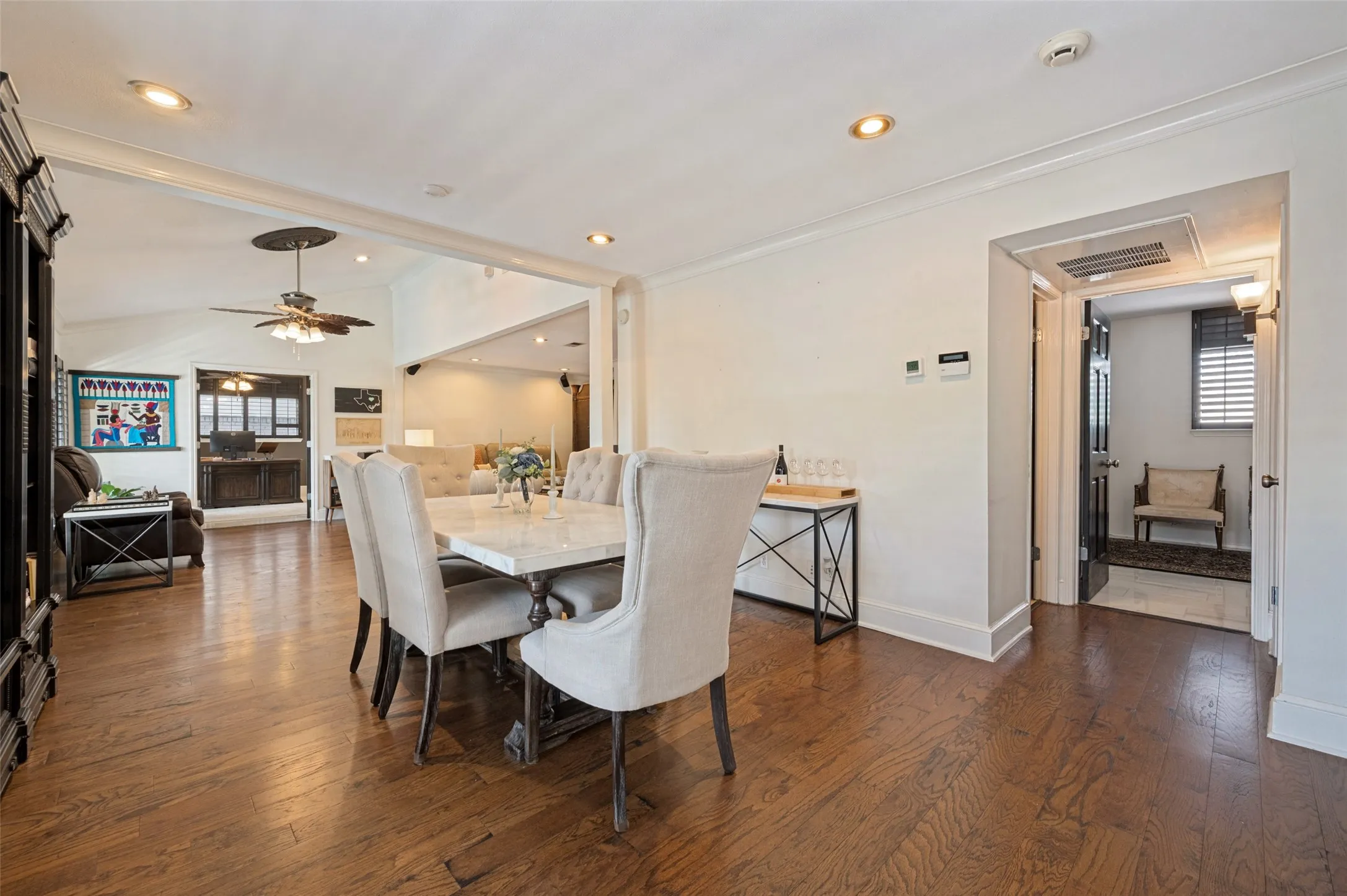 Hardwood flooring, recessed lighting, crown molding, and a vaulted ceiling with a ceiling fan