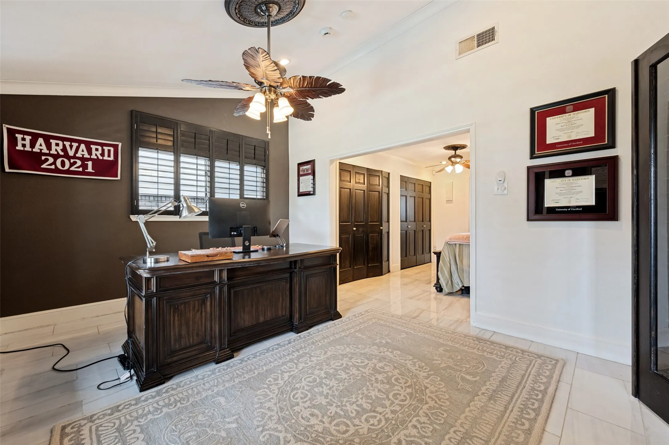 Recessed lighting, ceiling fan with ornate medallion, white tile flooring, and dark wood-tone louvered window treatments