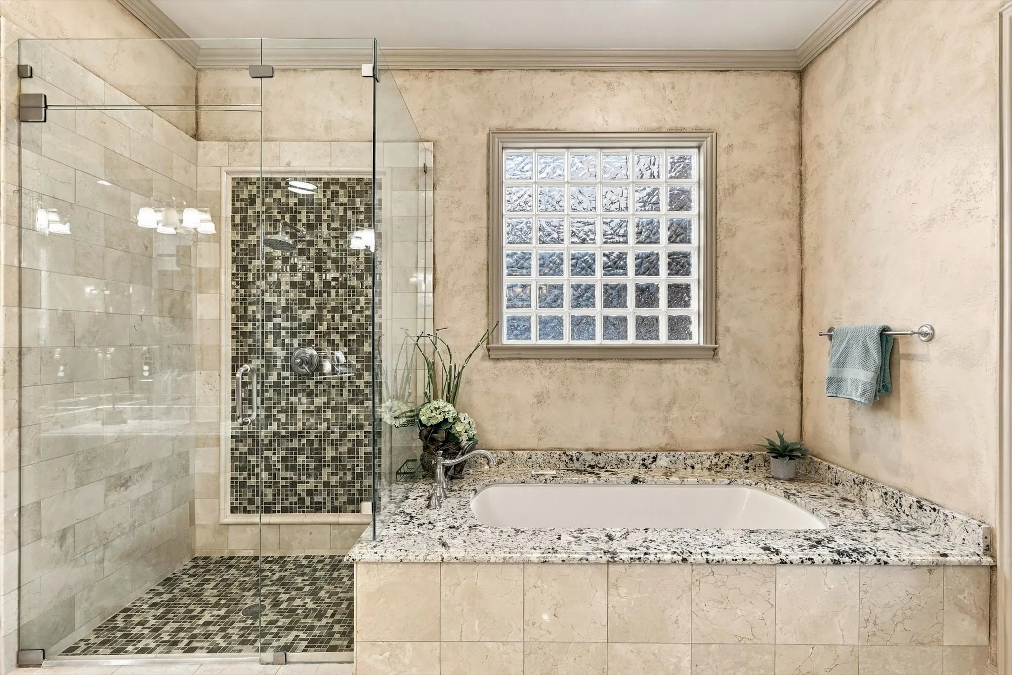 A generously sized jetted tub complements the walk-in shower, adding a relaxing, spa-like touch to the primary bath.