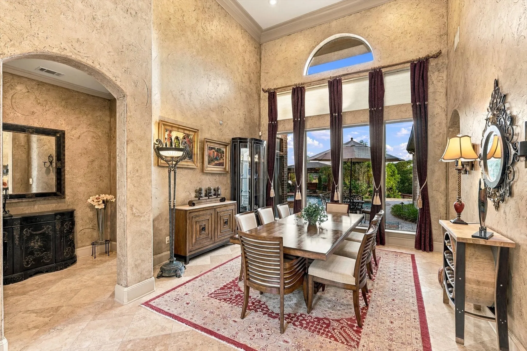 Just beyond the entry, the dining room makes a memorable first impression with soaring windows overlooking the backyard. With its flexible design, this room has also been enjoyed as a comfortable sitting room.