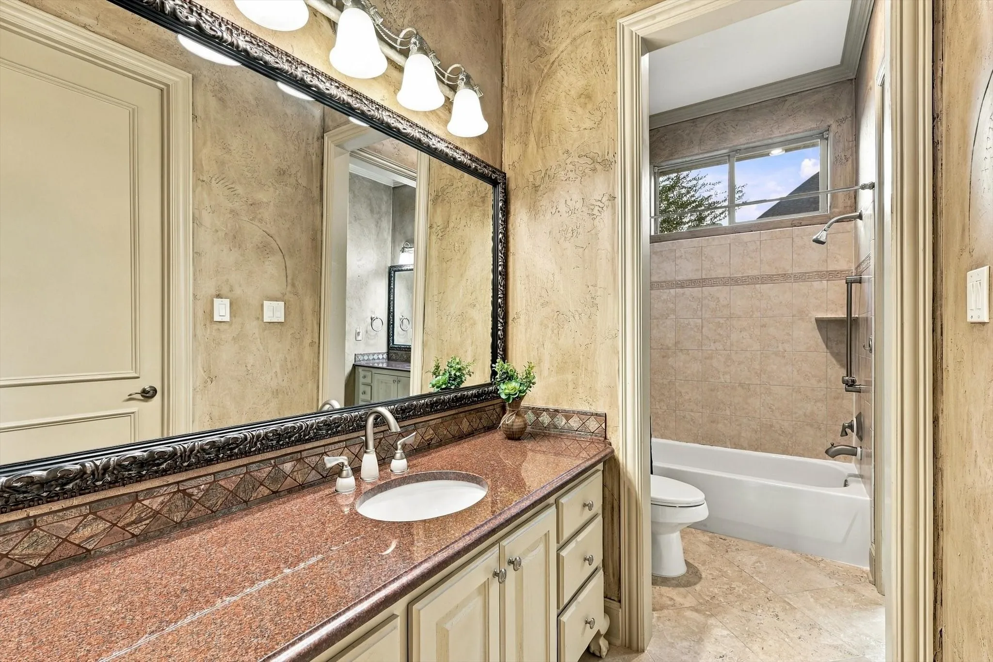 Even the secondary bathrooms reflect the home's attention to quality, with beautiful granite countertops and custom cabinetry.