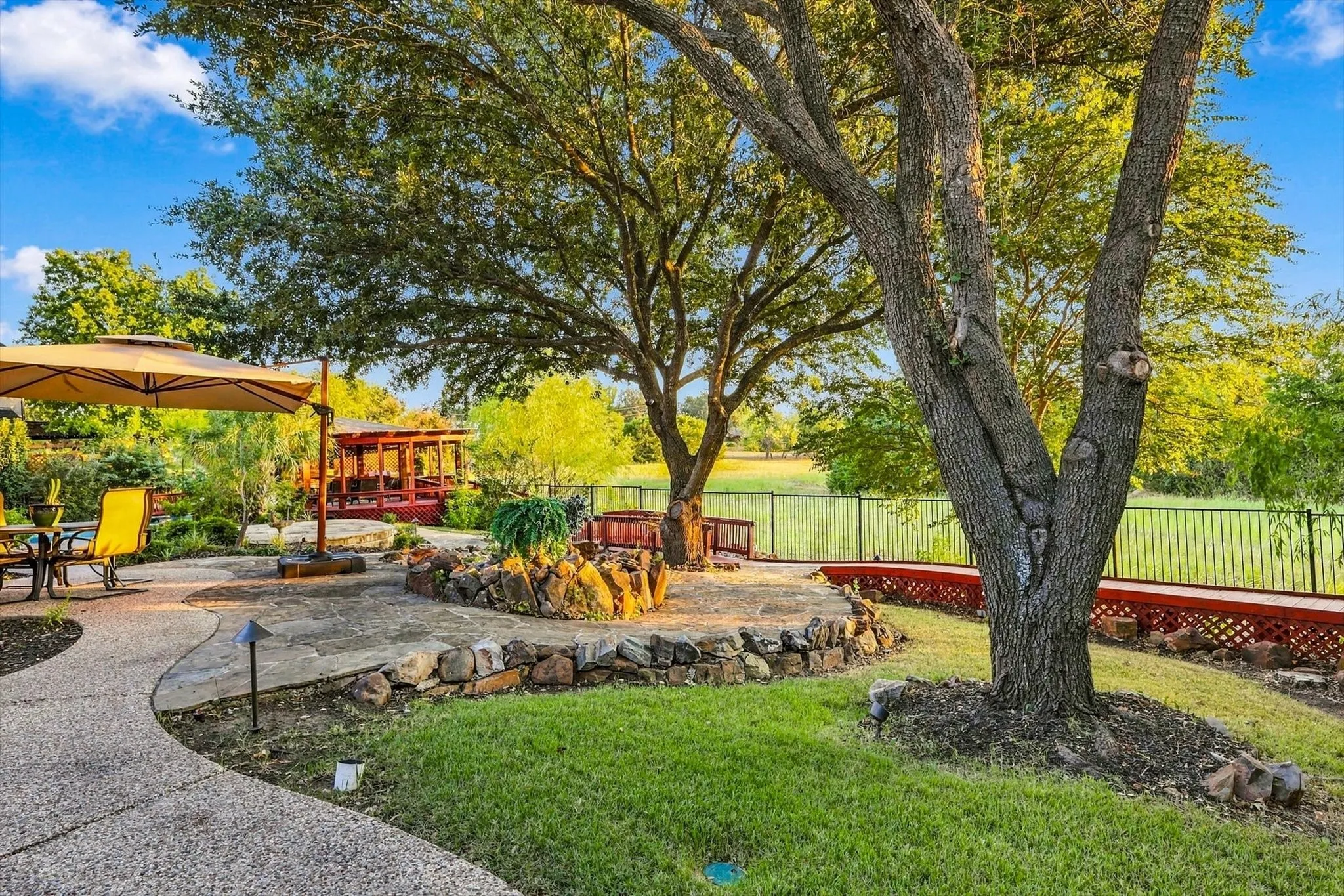 Wander the walking paths beneath mature shade trees and enjoy the peaceful greenspace beyond, with the occasional roadrunner, owl or other wildlife adding to the charm of this private outdoor setting.