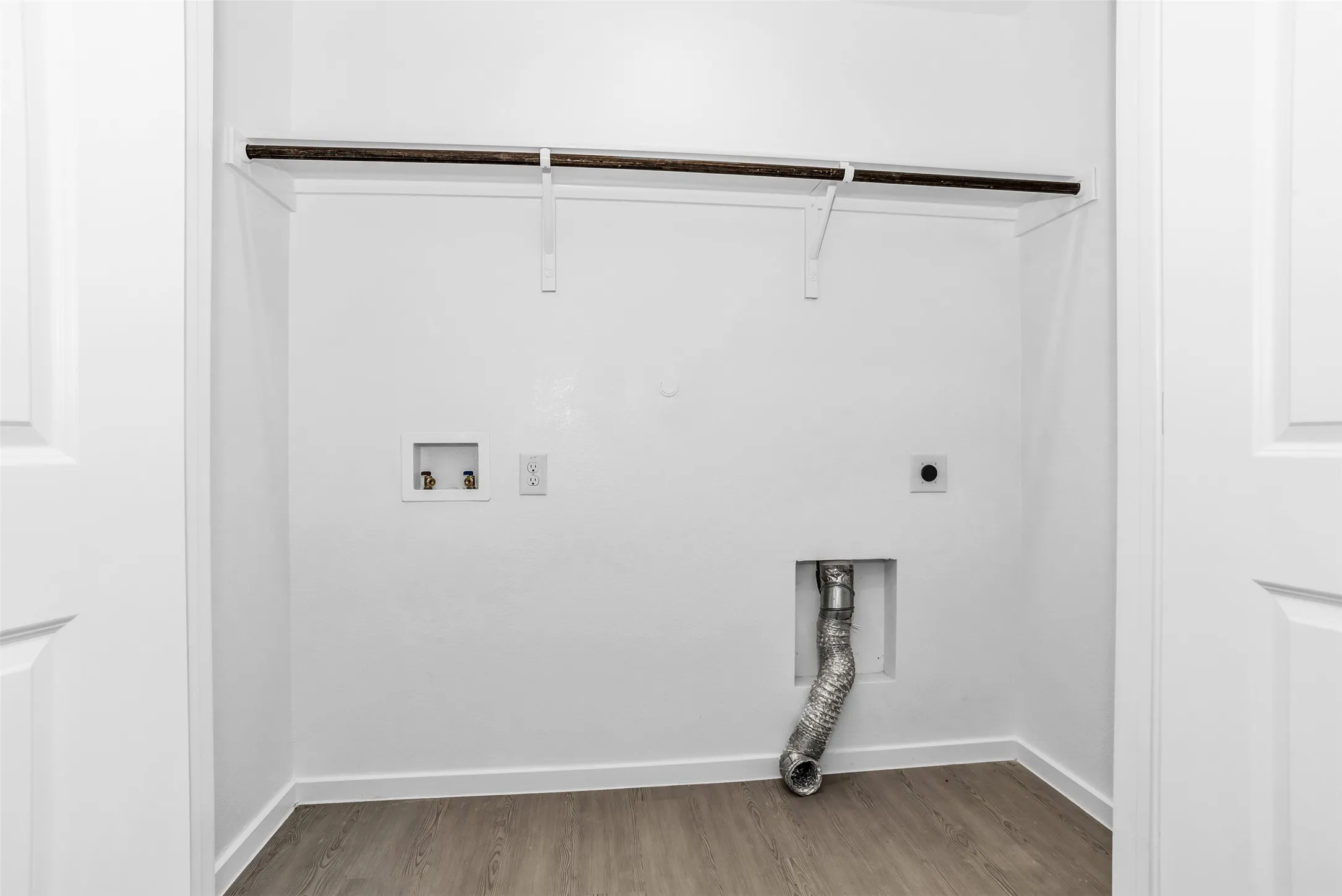 Laundry room with wood finished floors, electric dryer hookup, and washer hookup