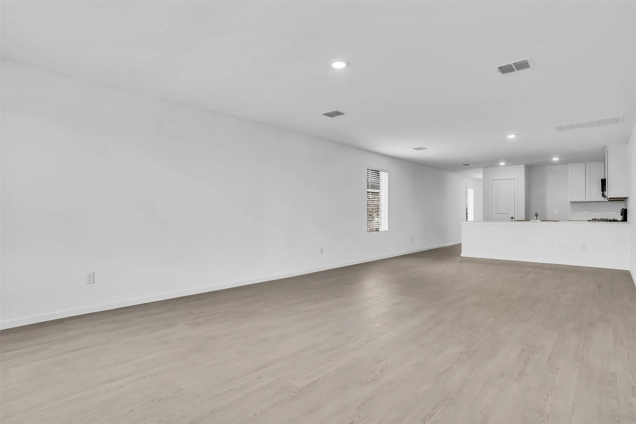Unfurnished living room featuring recessed lighting and light wood-type flooring