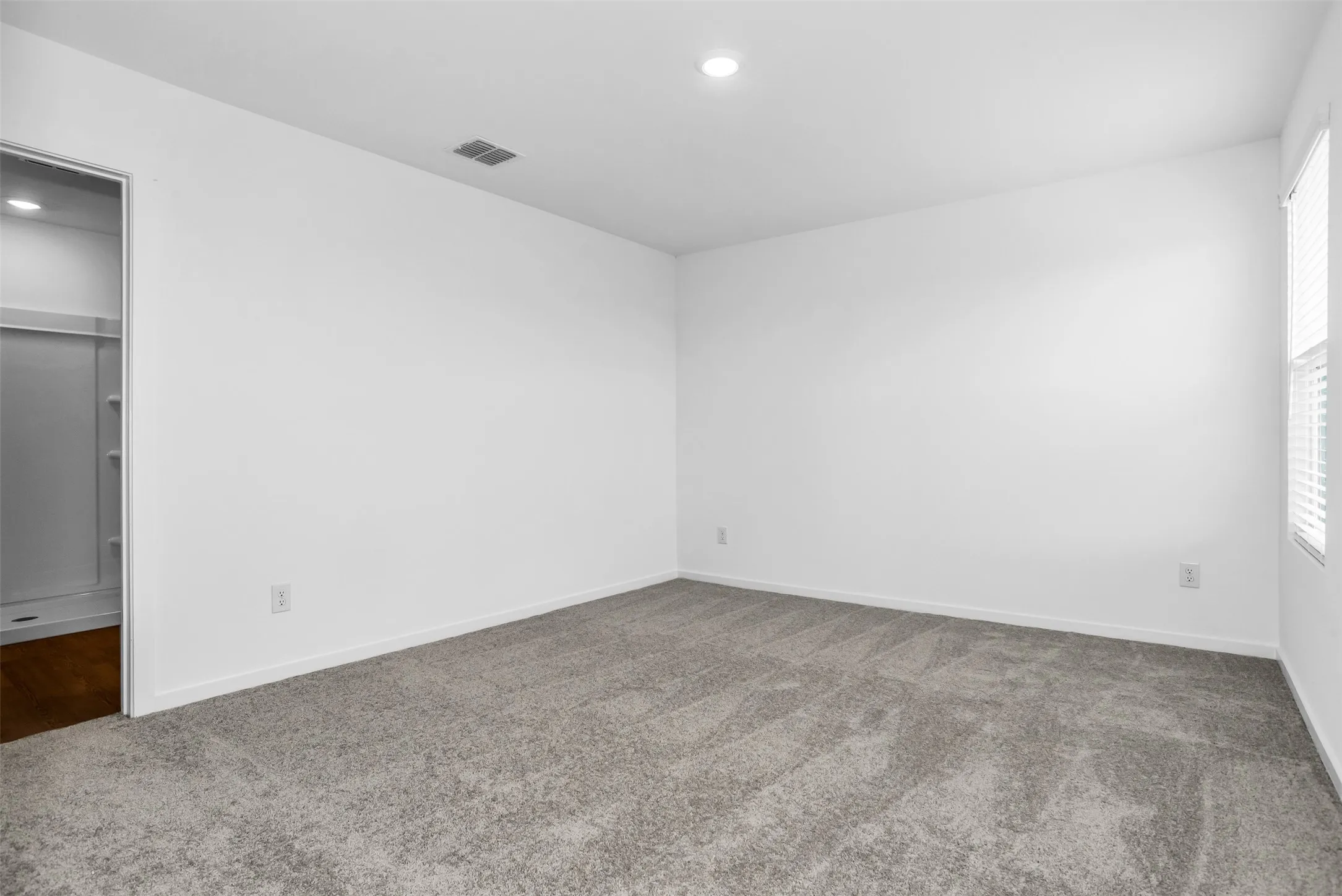 Unfurnished bedroom with carpet flooring, recessed lighting, and a spacious closet
