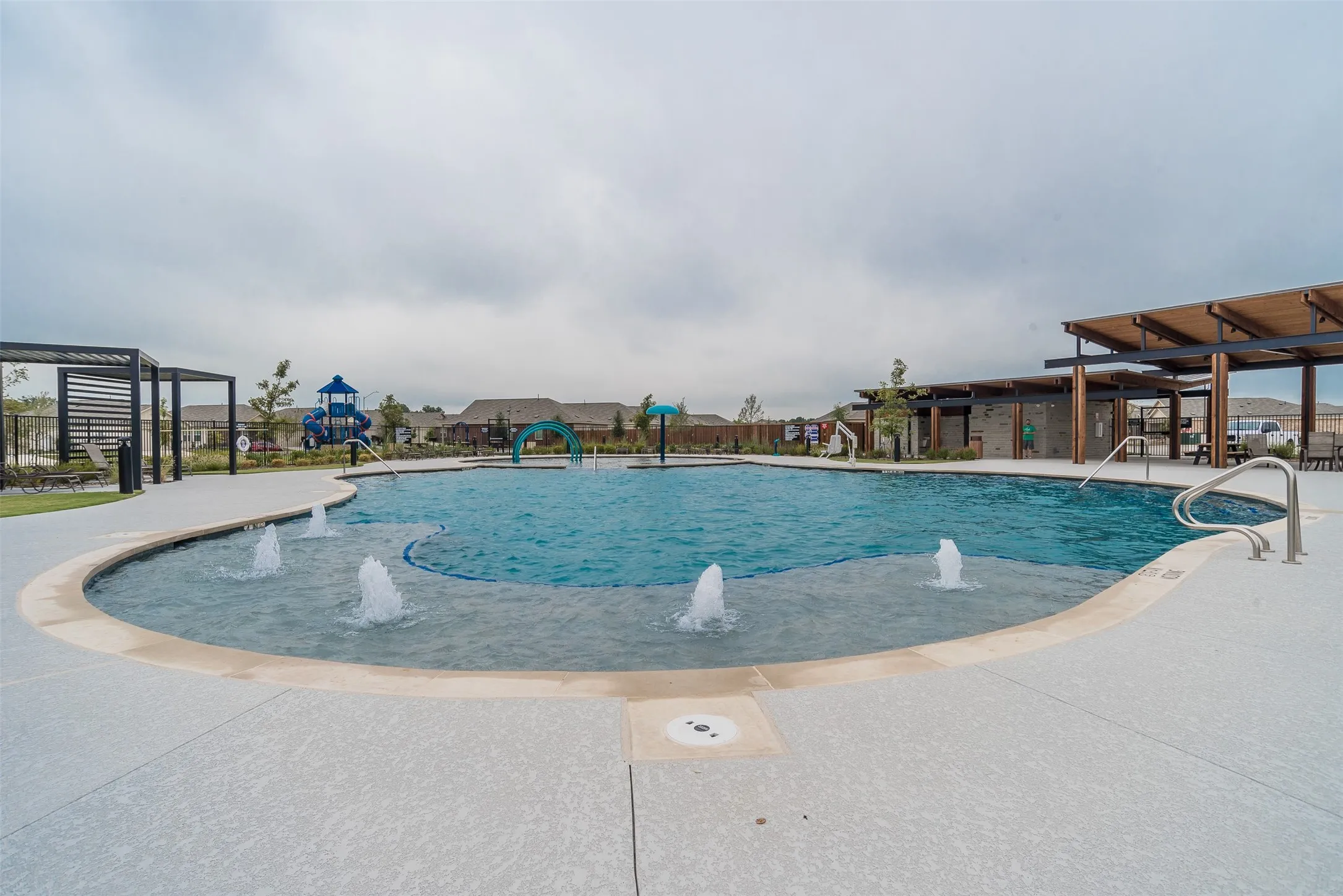 Community pool with a patio