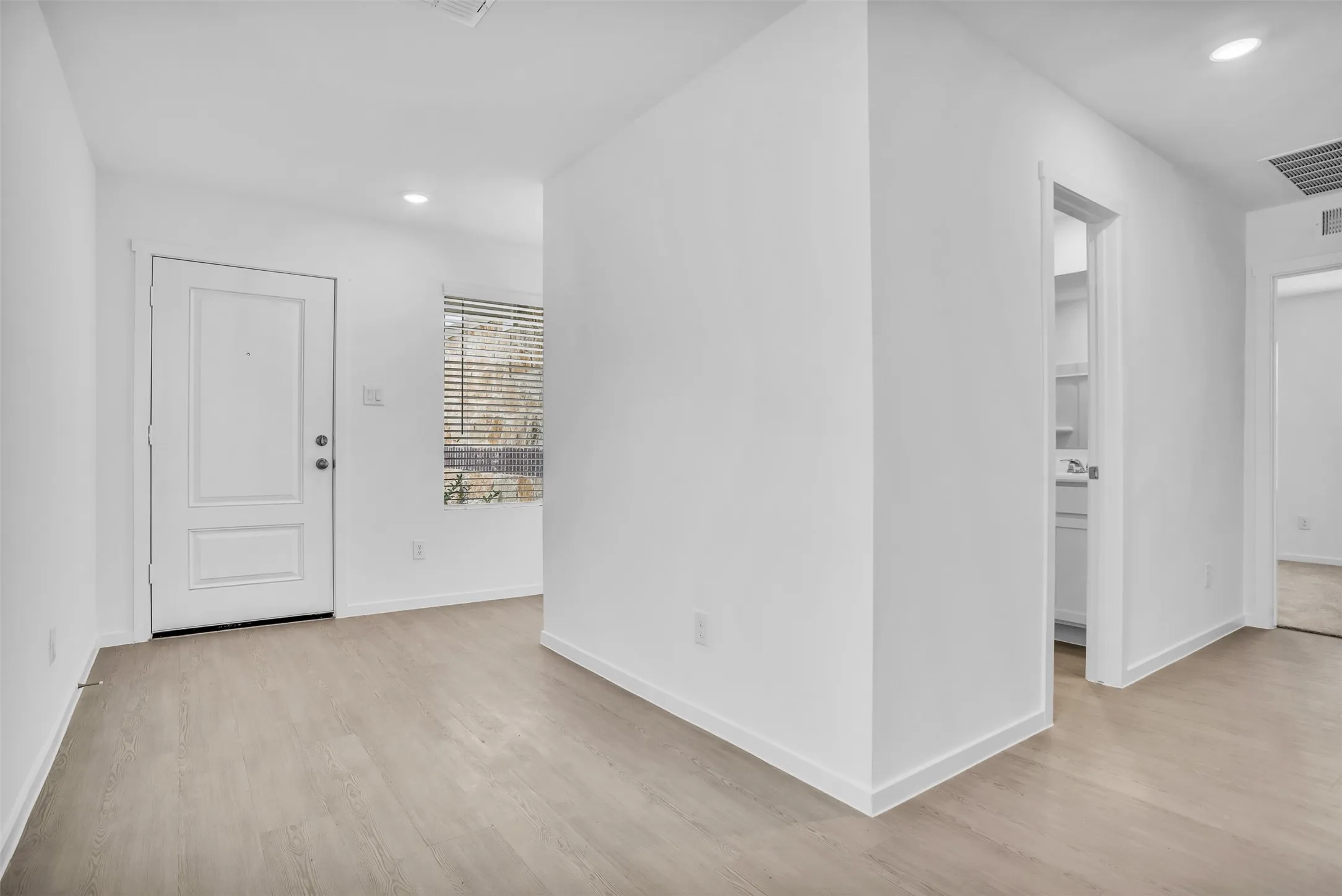 Entryway with recessed lighting and light wood-type flooring