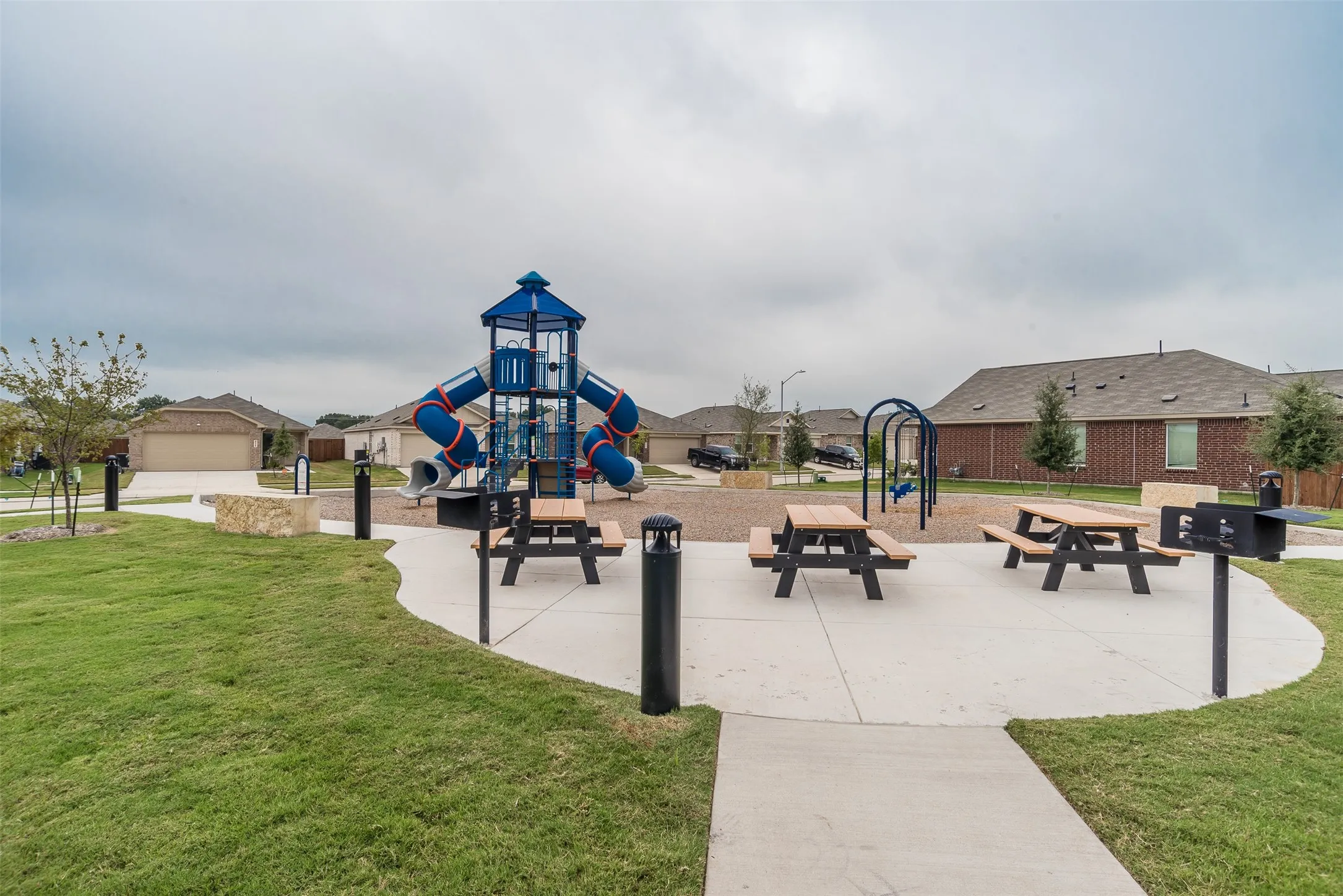 Community playground with a yard and a residential view