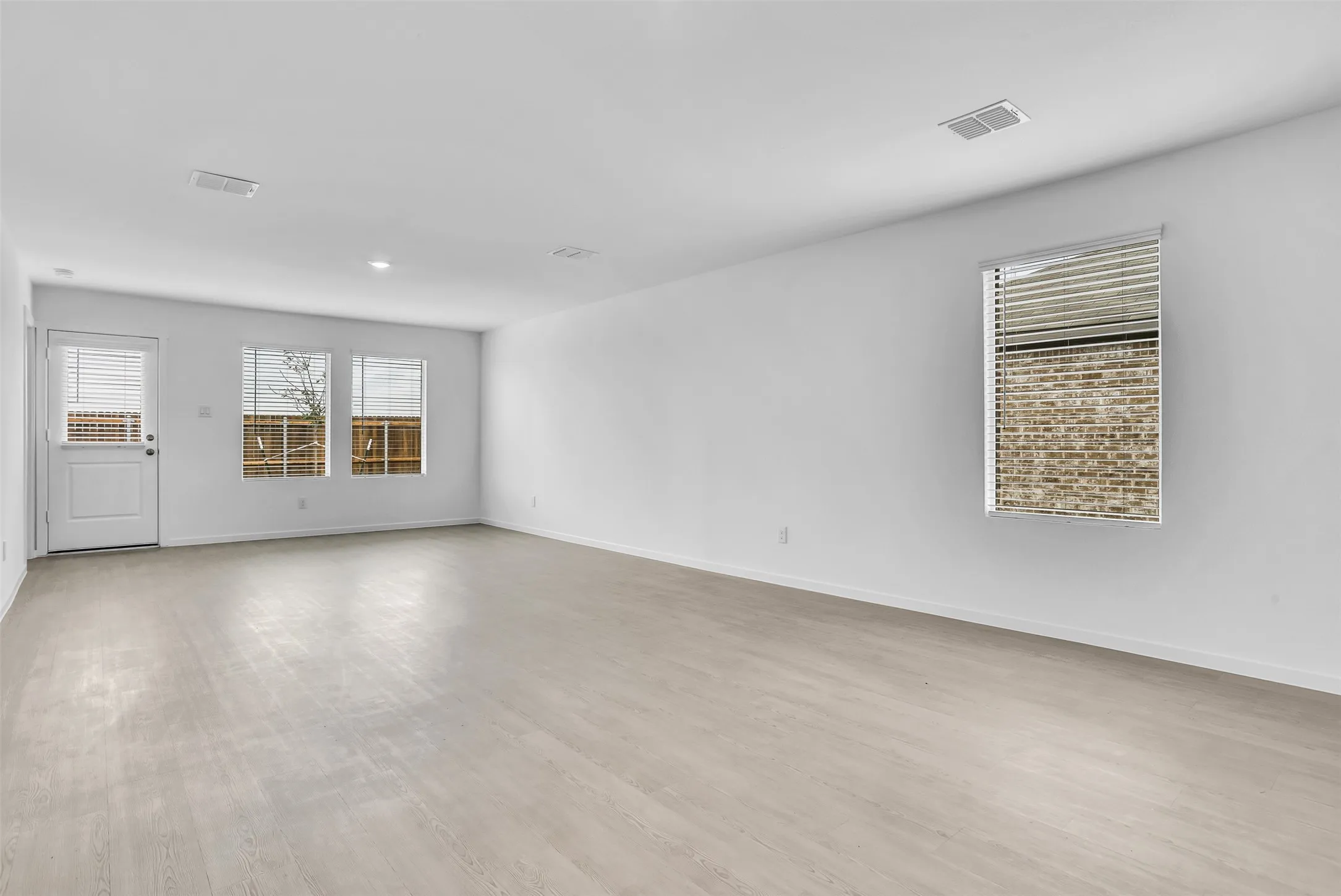 Spare room with light wood-type flooring and baseboards