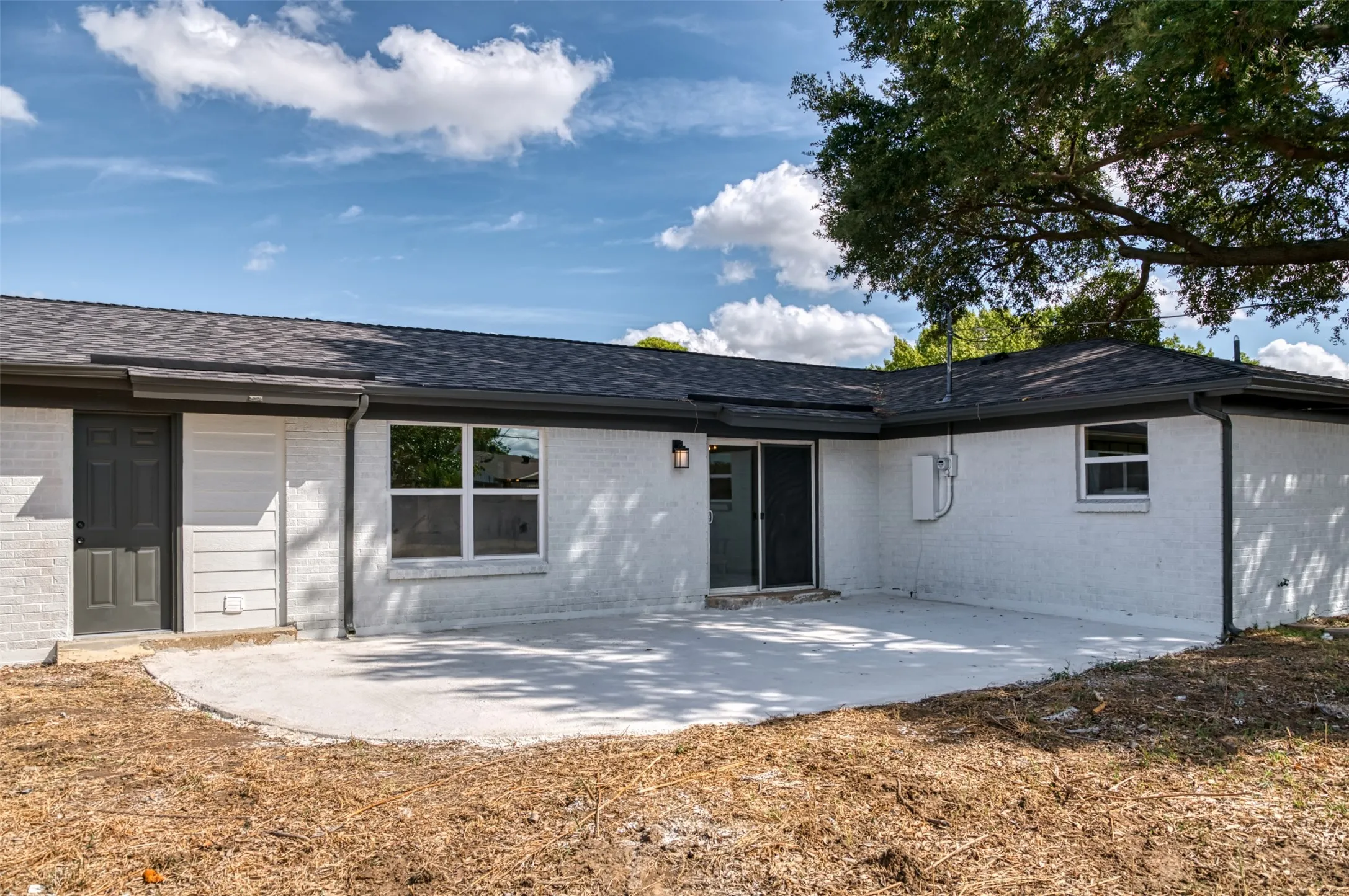 Large back patio with shade tree coverage