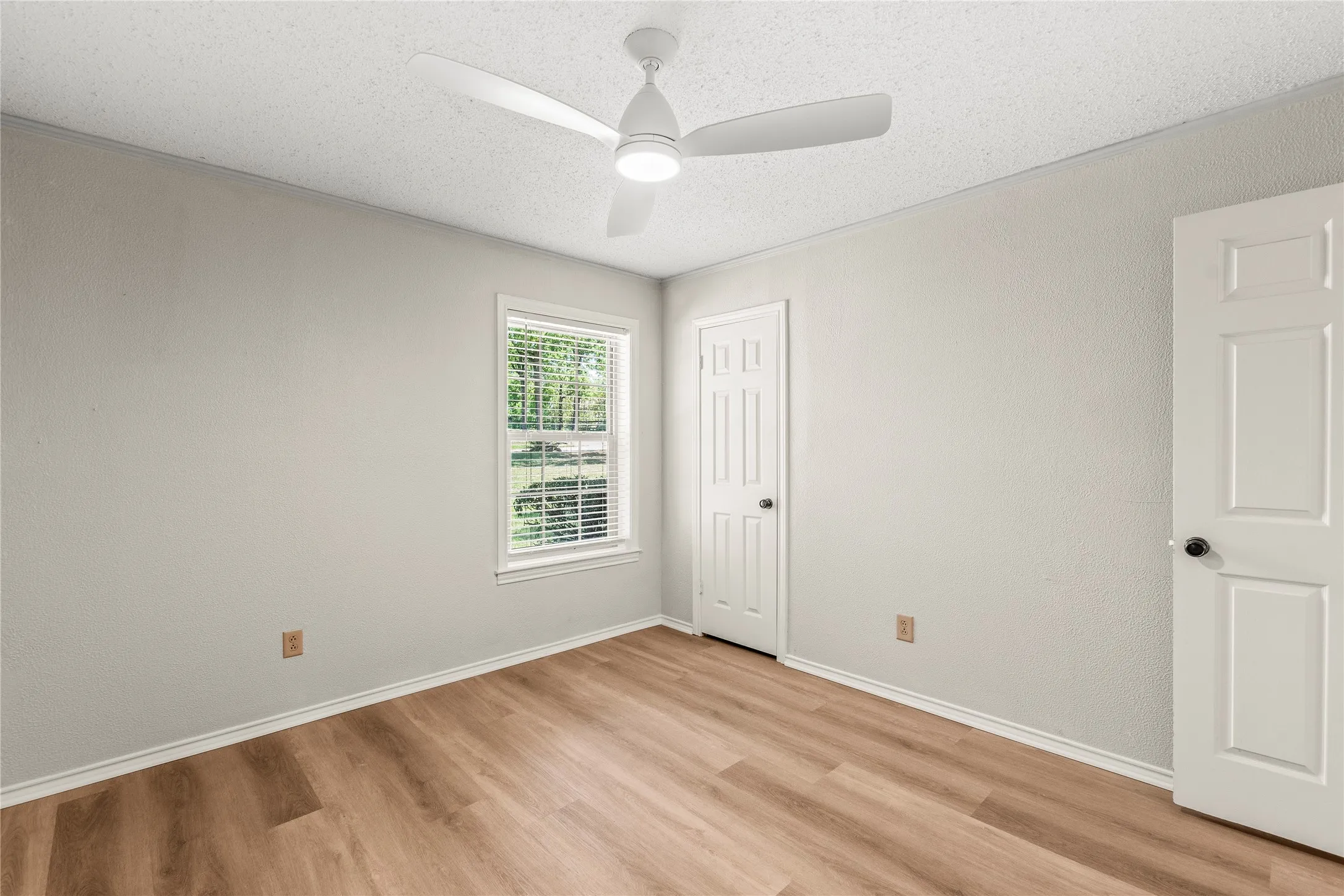 Primary en suite Bedroom freshly painted with new ceiling fan, luxury vinyl plank flooring.