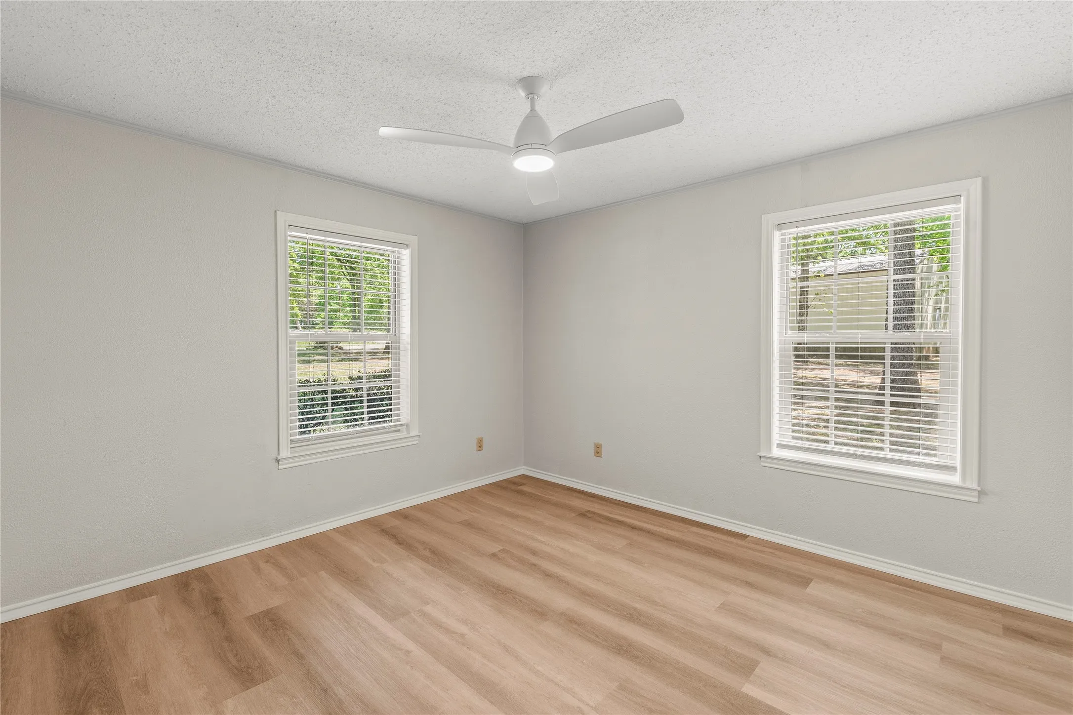 Bedroom 2 with new ceiling fan, luxury vinyl plank flooring.