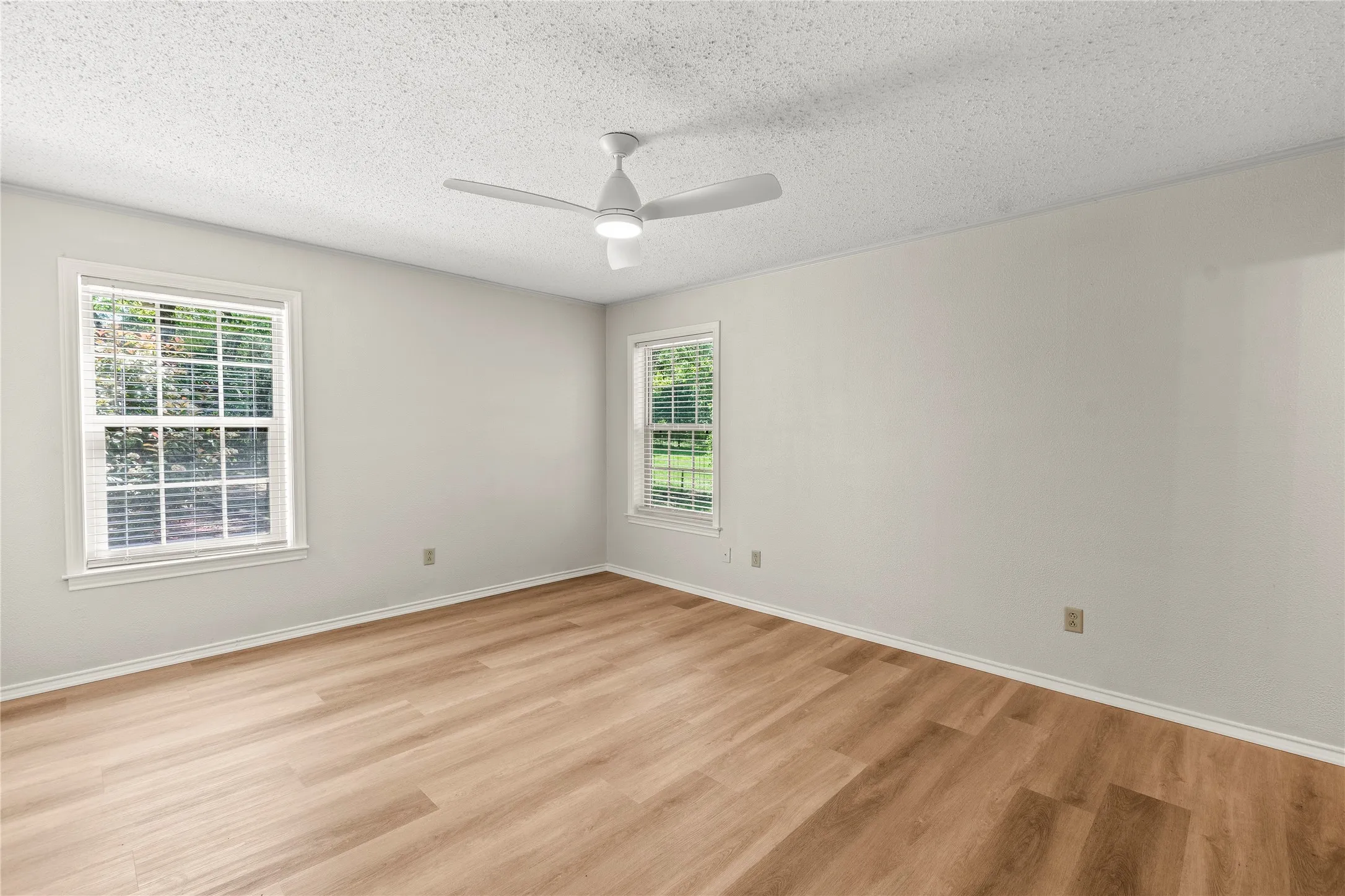 Bedroom 3 freshly painted with new ceiling fan, luxury vinyl plank flooring