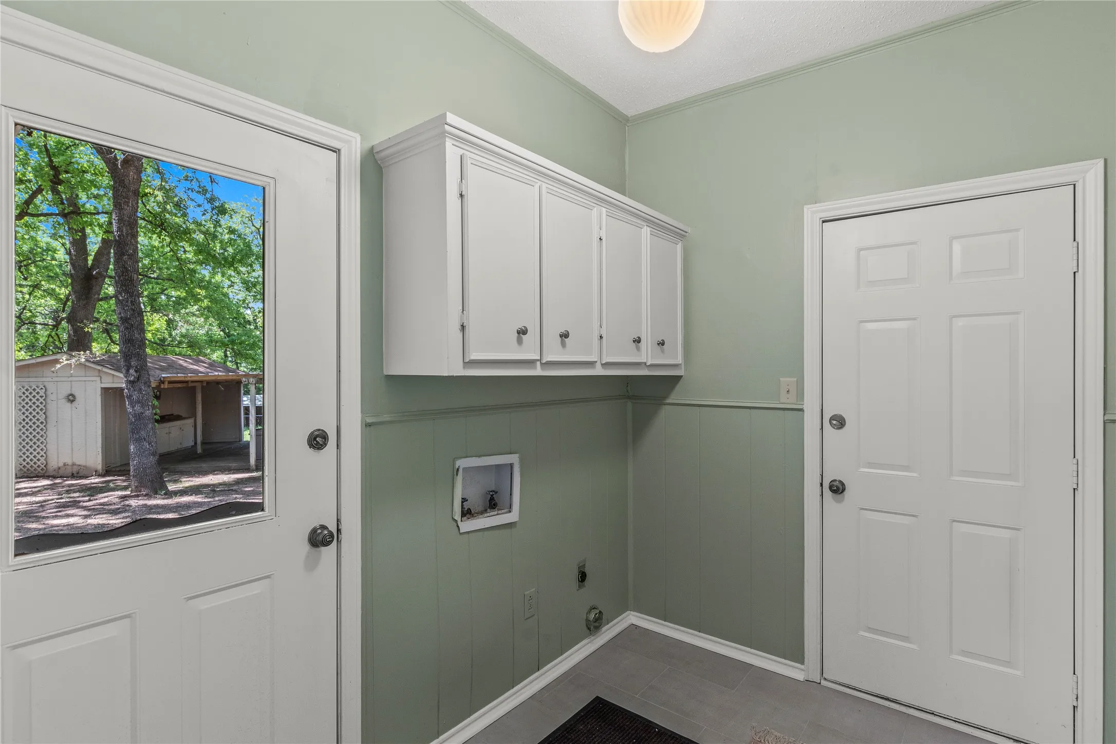 Freshly painted utility room with new luxury vinyl plank floor and room for full size washer and dryer.