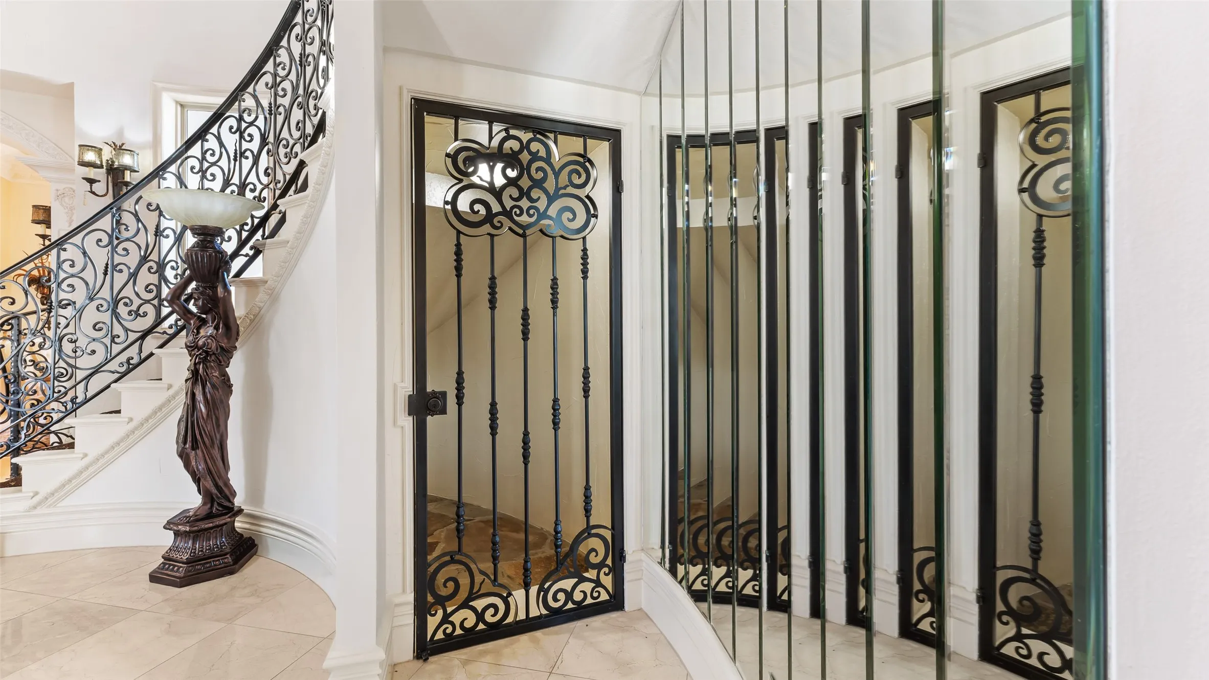 Curved staircase with ornate wrought iron railing