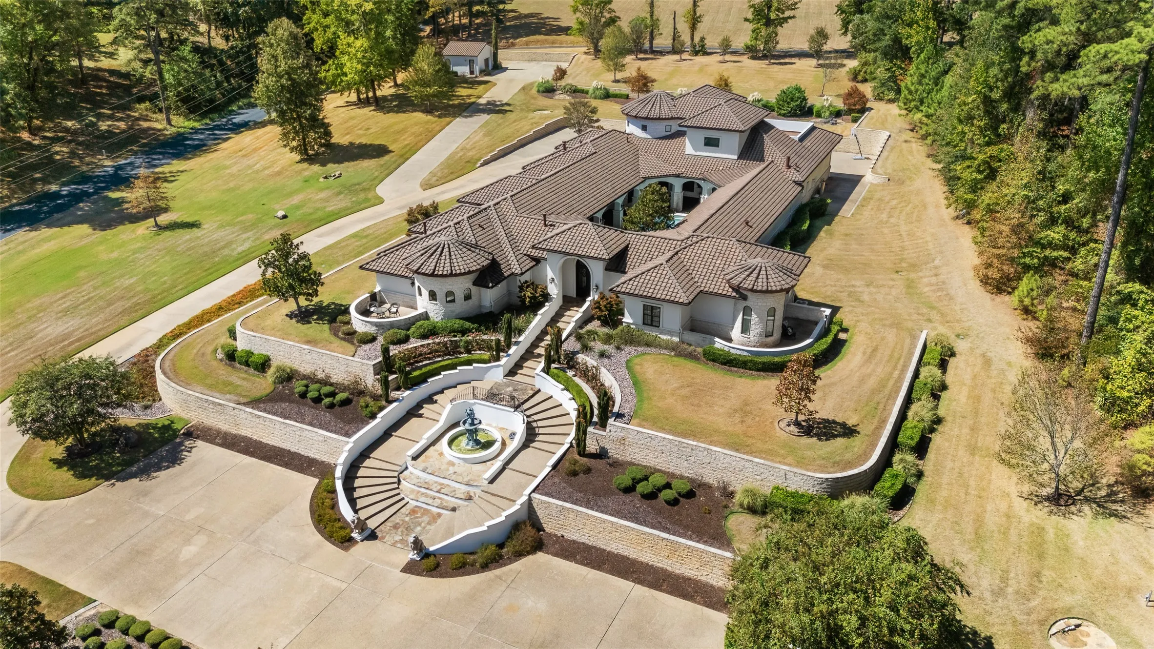 Stucco exterior with a tile roof and multiple turrets