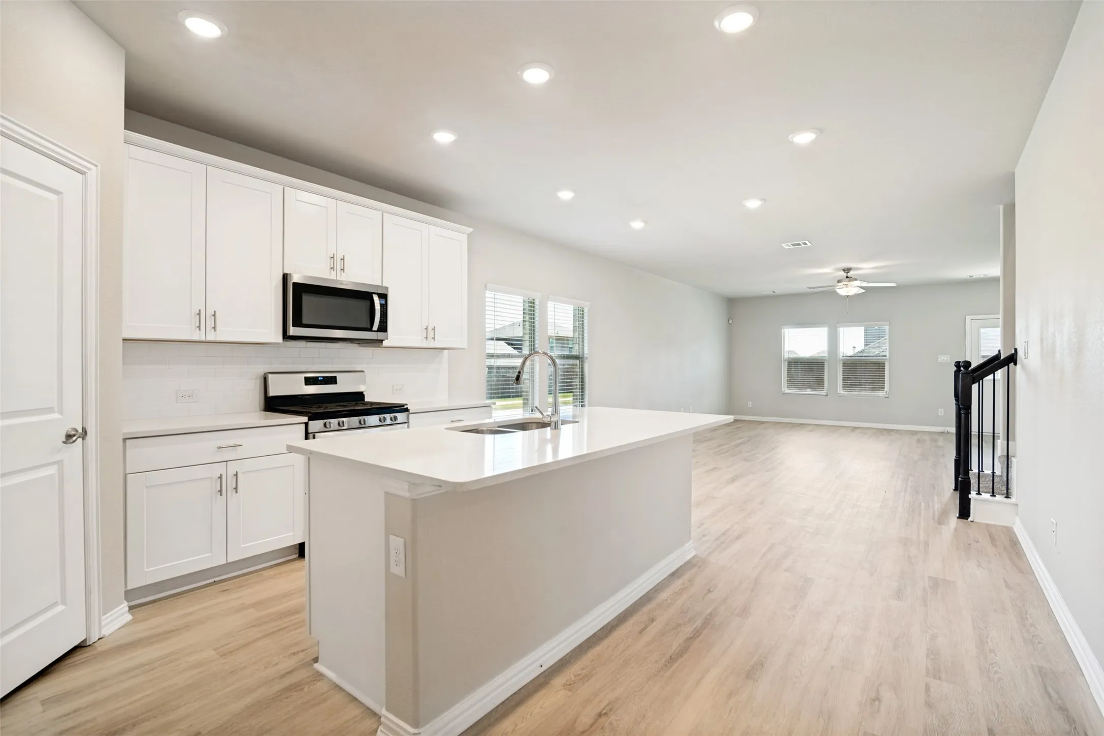 Open-concept living space with wood-finish flooring