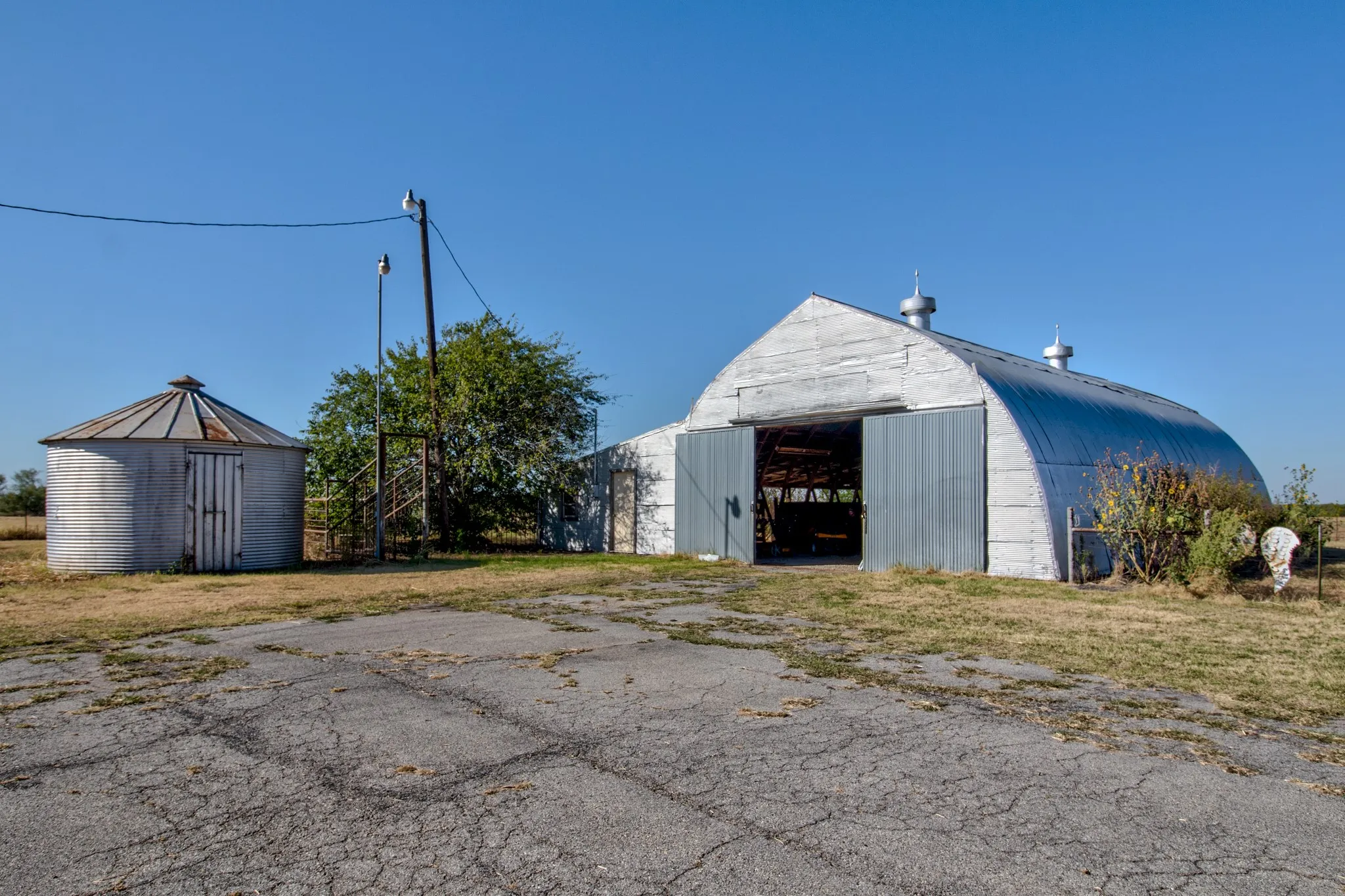 Large barn and original grain bin, offer character, storage, and country charm.