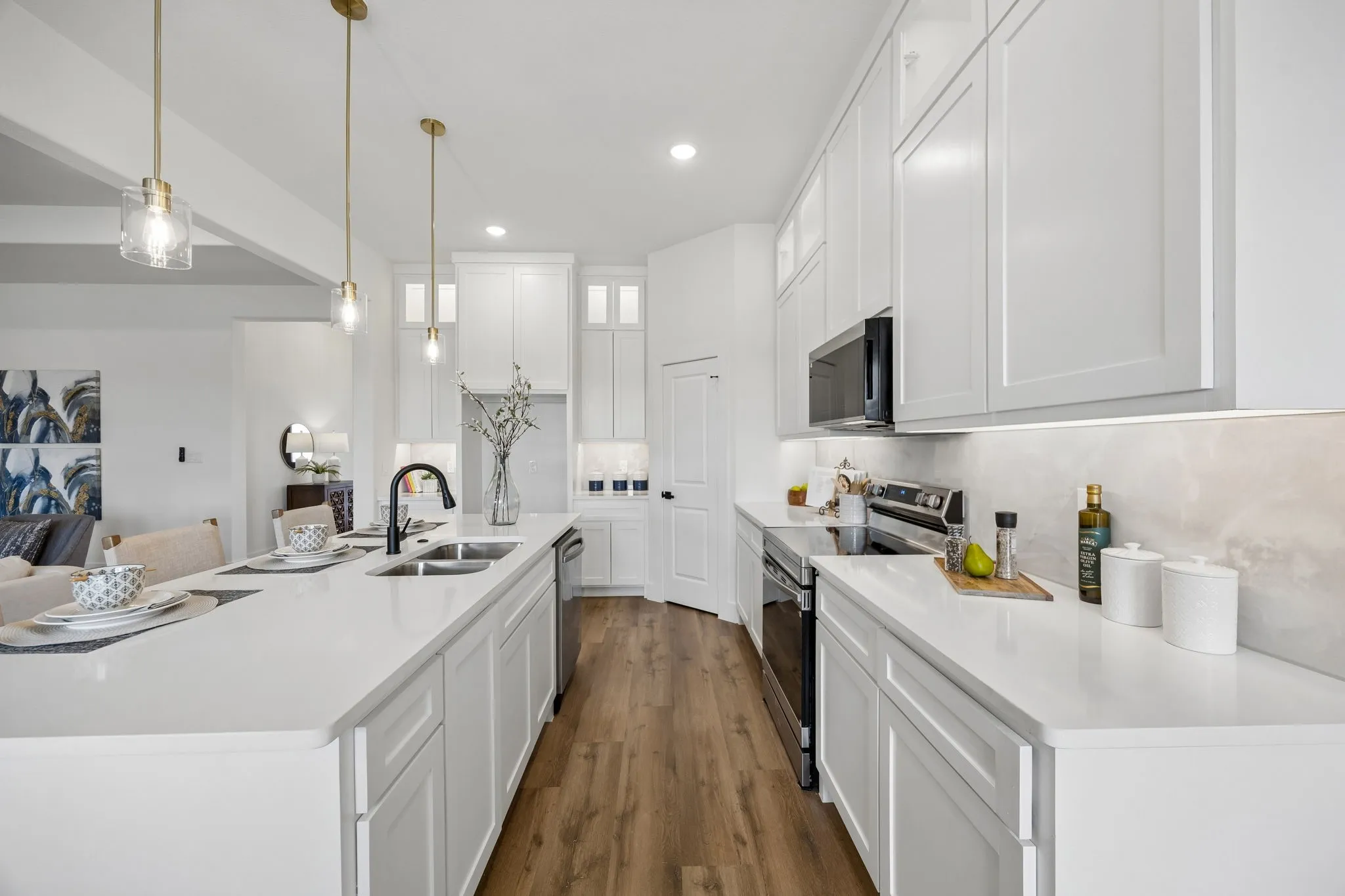 Here you can see the smooth top electric range, built in microwave and pantry
