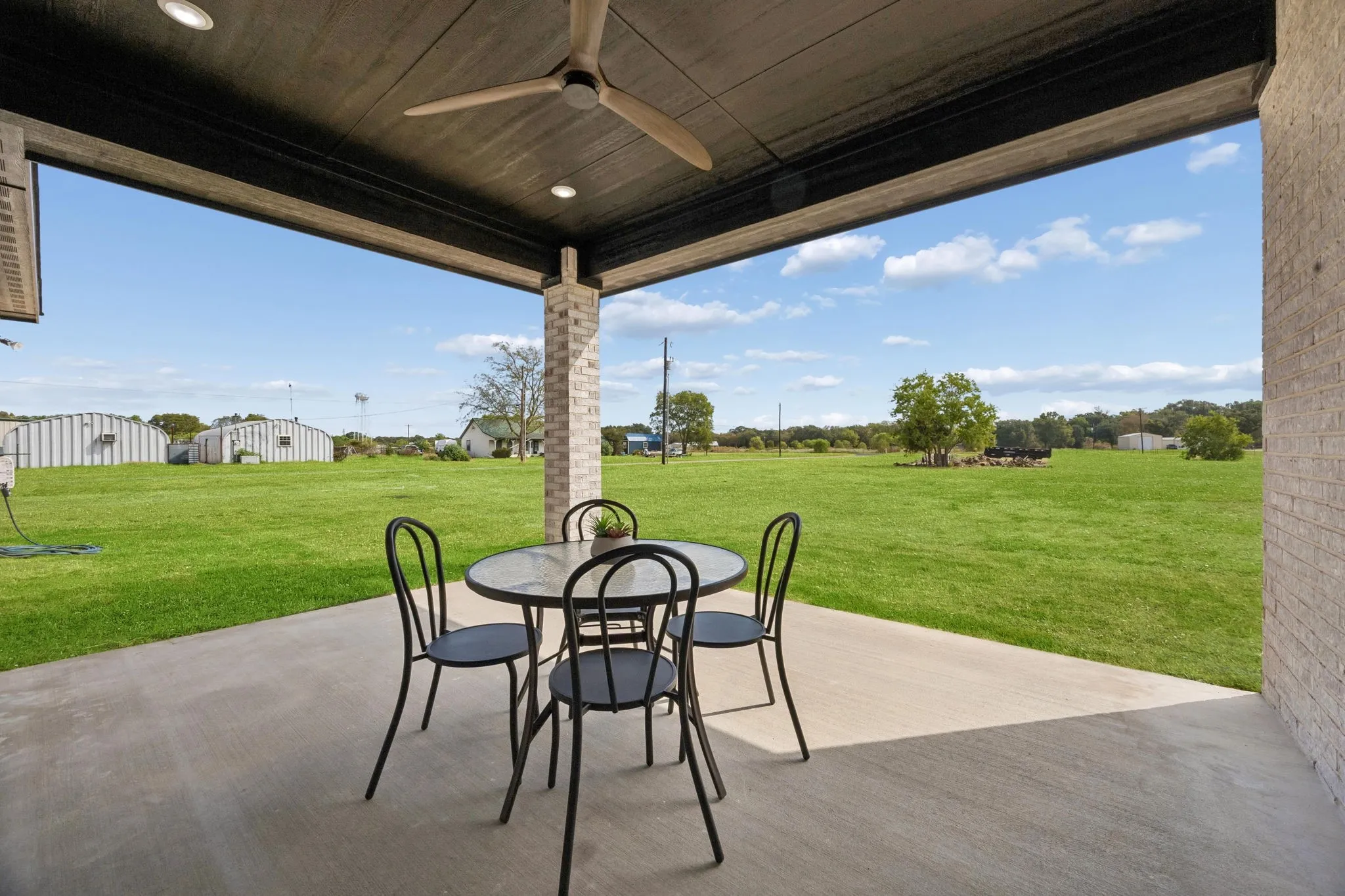 Covered patio with a ceiling fan, recessed lighting, and views of the back yard
