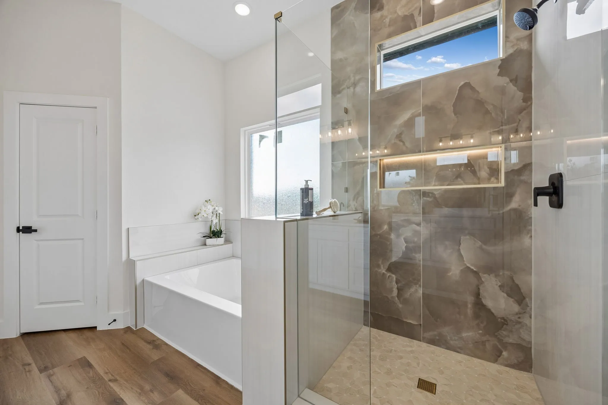 Another view of the primary frameless glass shower