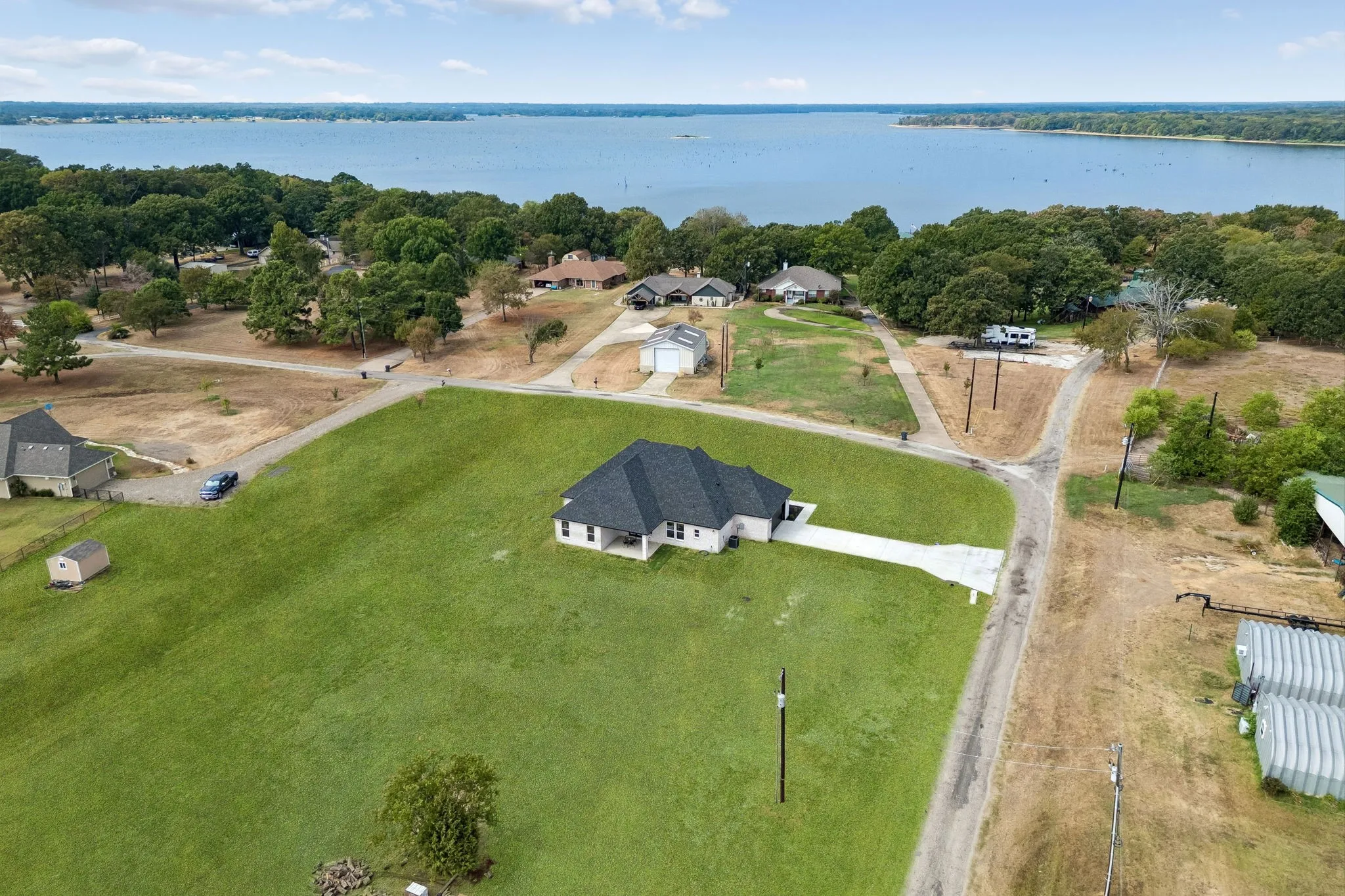 Aerial view of this newley constructed home sitting on over an acre near the lake.