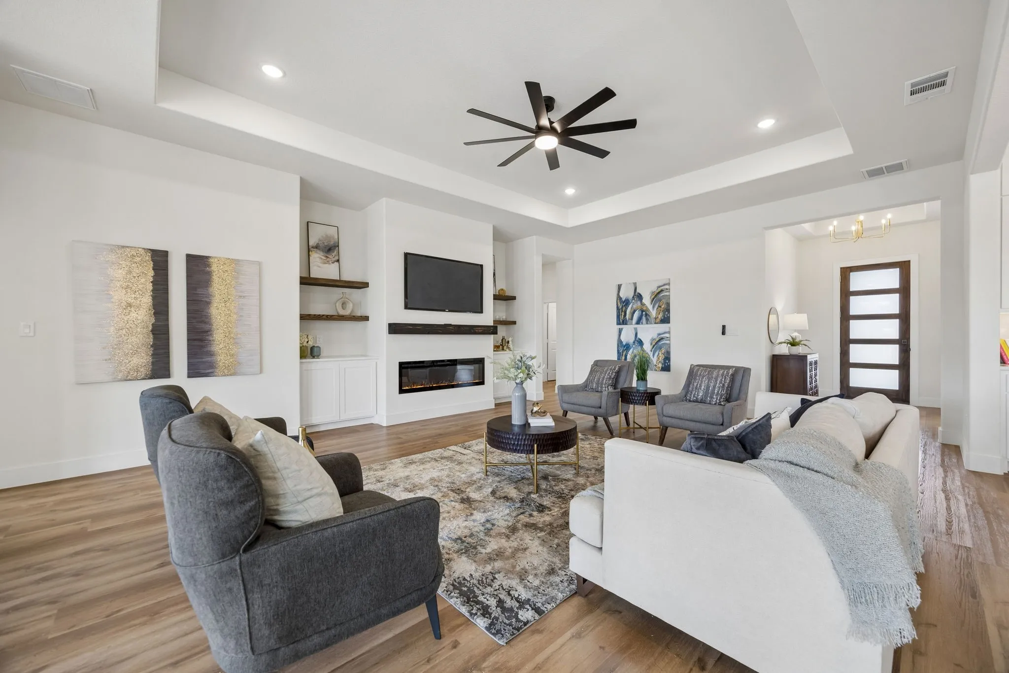 Spacious living room with built in shelves and an electric fireplace
