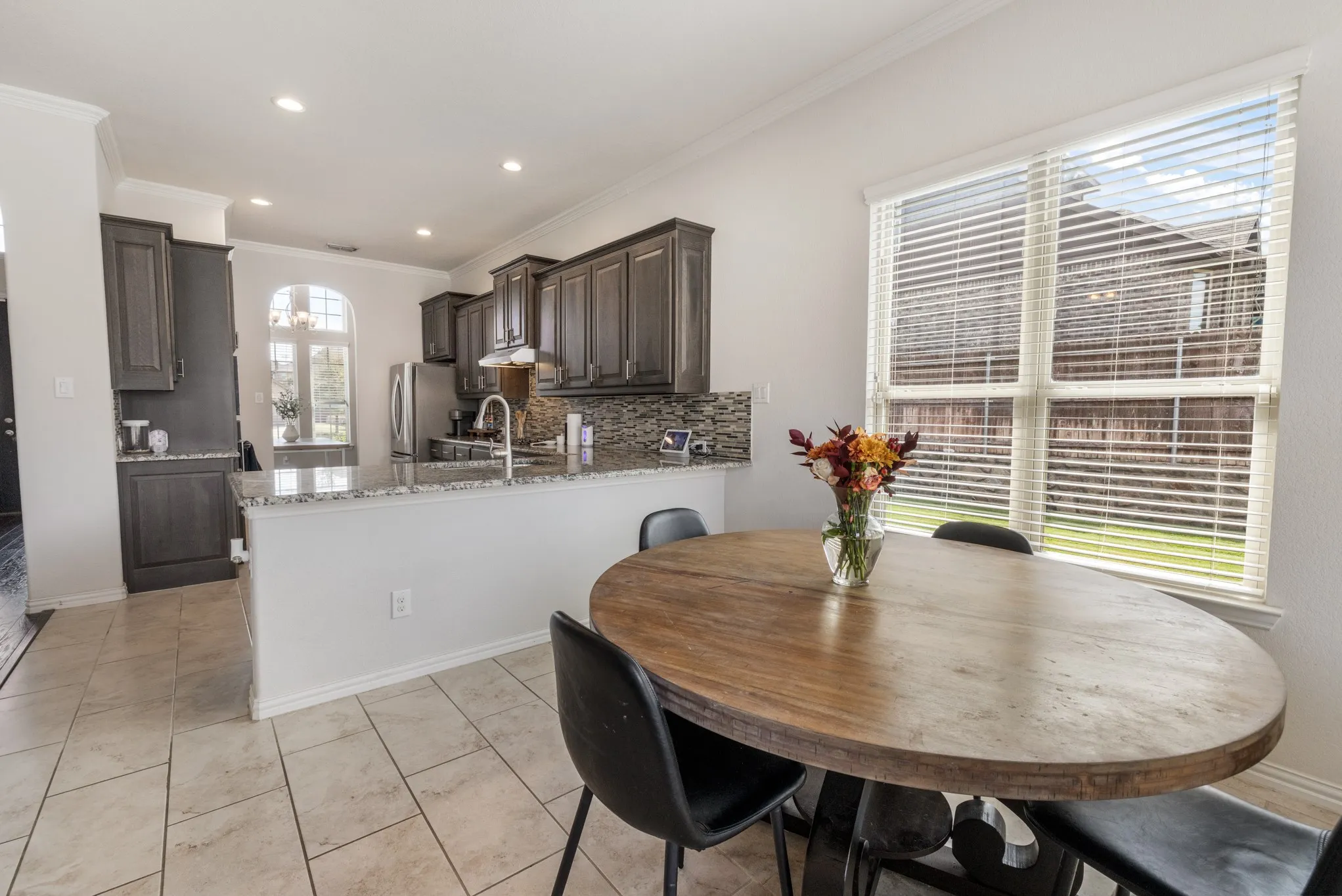 Kitchen featuring dark wood cabinetry, granite countertops, and stainless steel appliances