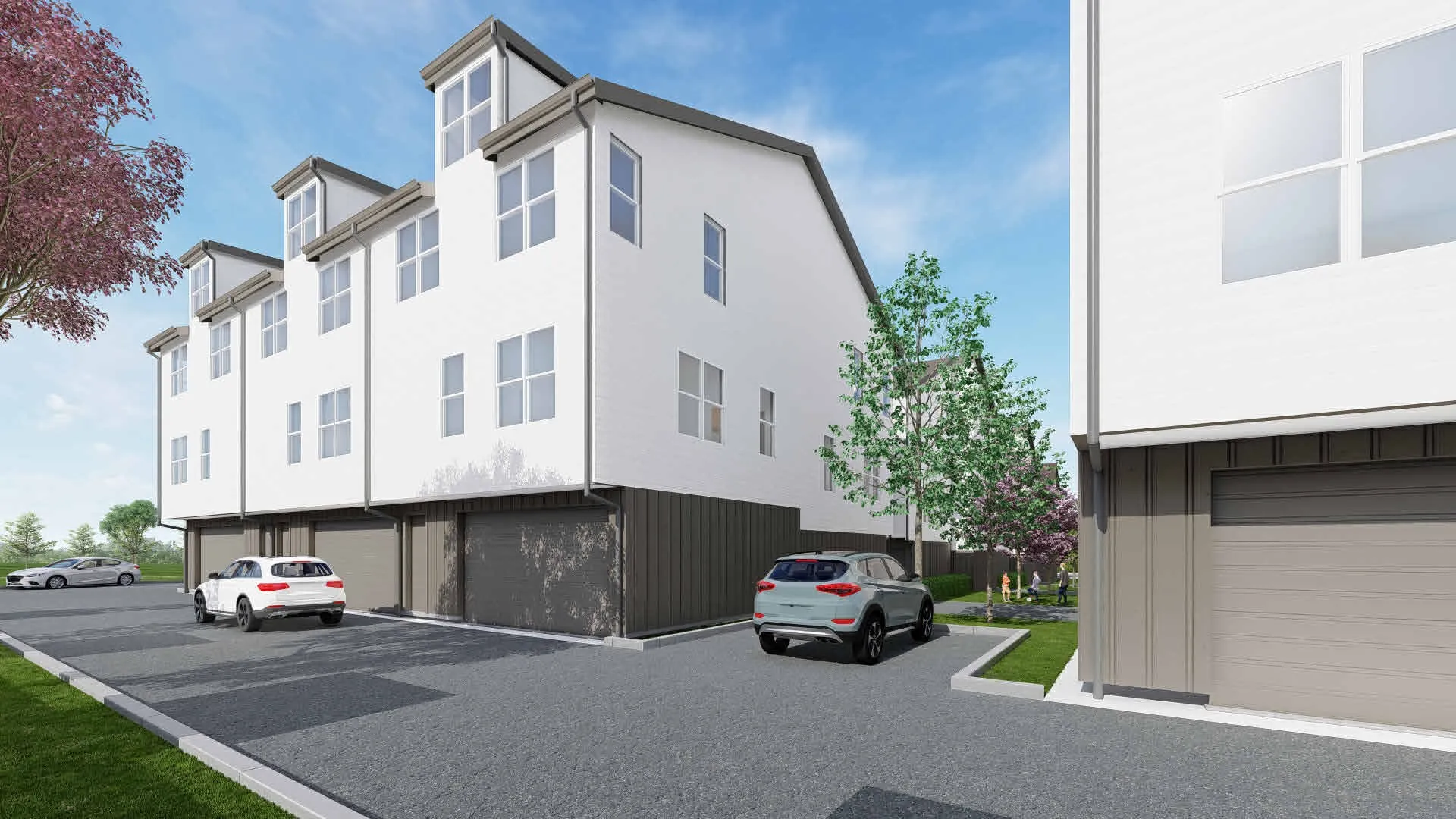 Modern townhomes featuring a multi-story design, white exterior cladding, individual garage entrances, dormer windows, and a paved driveway