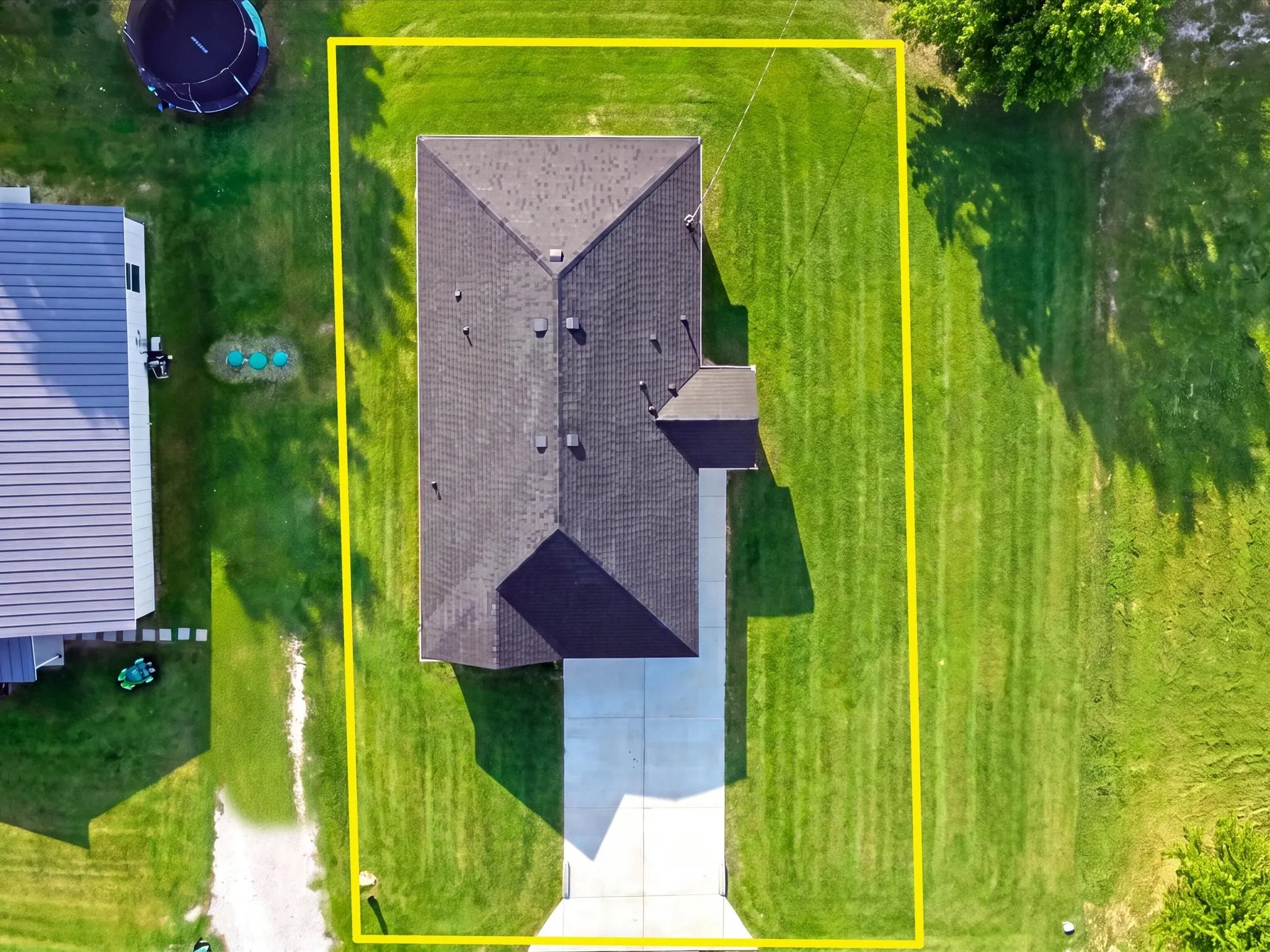 Expansive green lawn surrounds the property