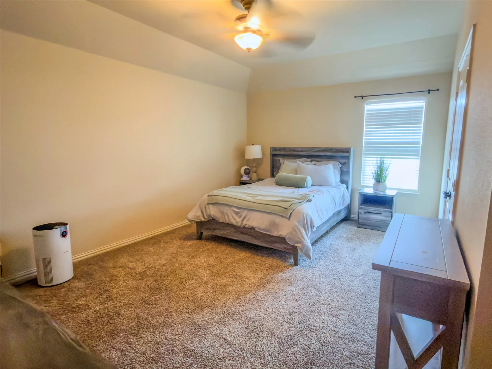 Carpeted flooring, ceiling fan with integrated lighting, window with blinds, and painted walls
