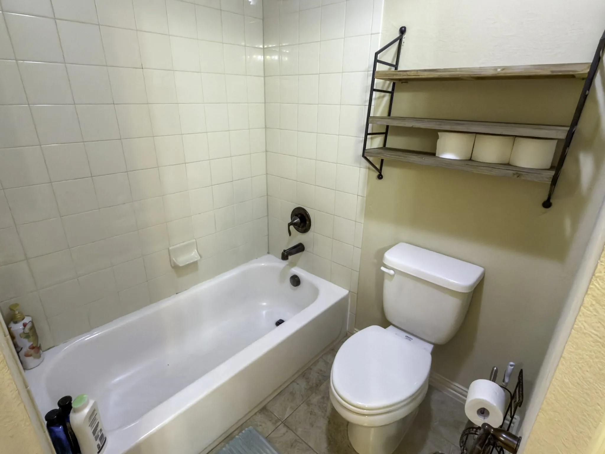 Tub and shower combination with white tile surround