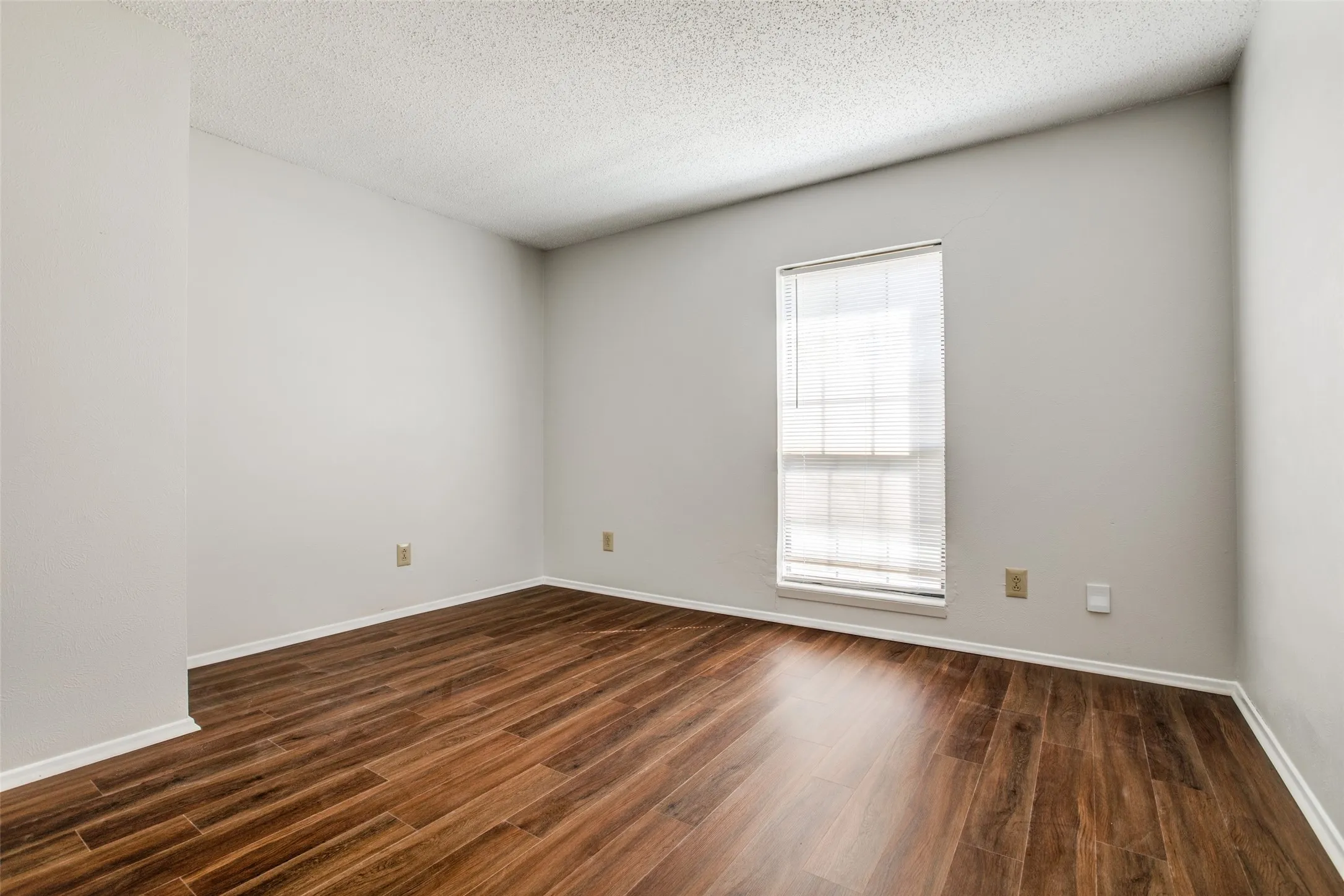 Warm wood-finish flooring complements light-toned walls