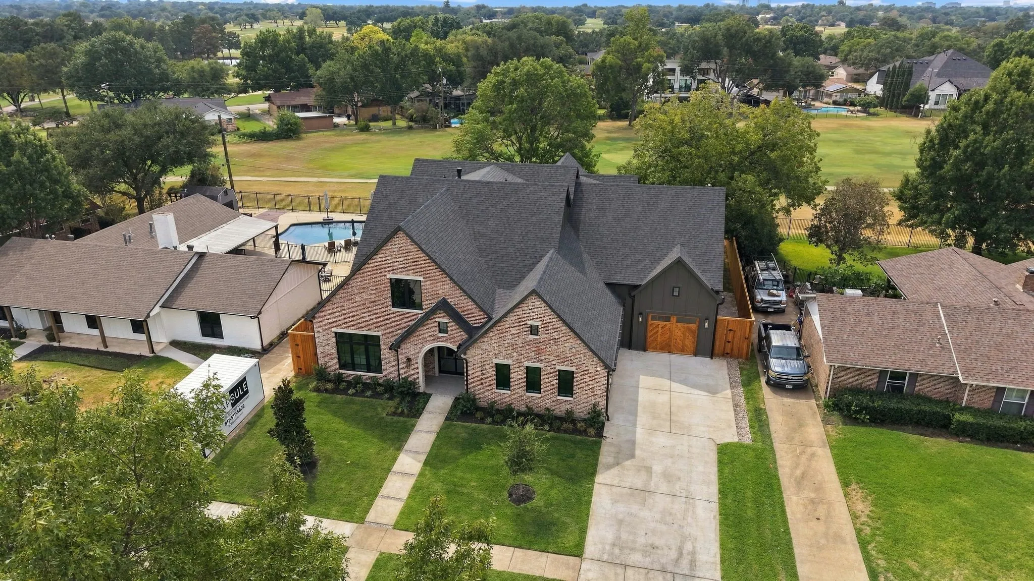 Brick and dark siding exterior with arched entry