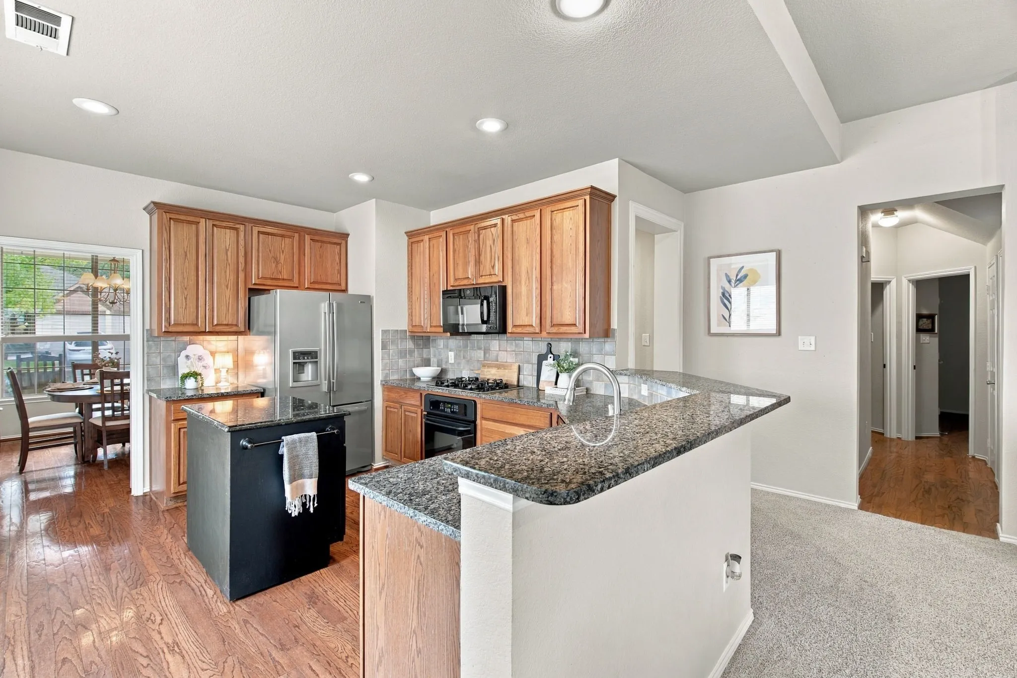 Hardwoods in the kitchen make this an elevated looking space.