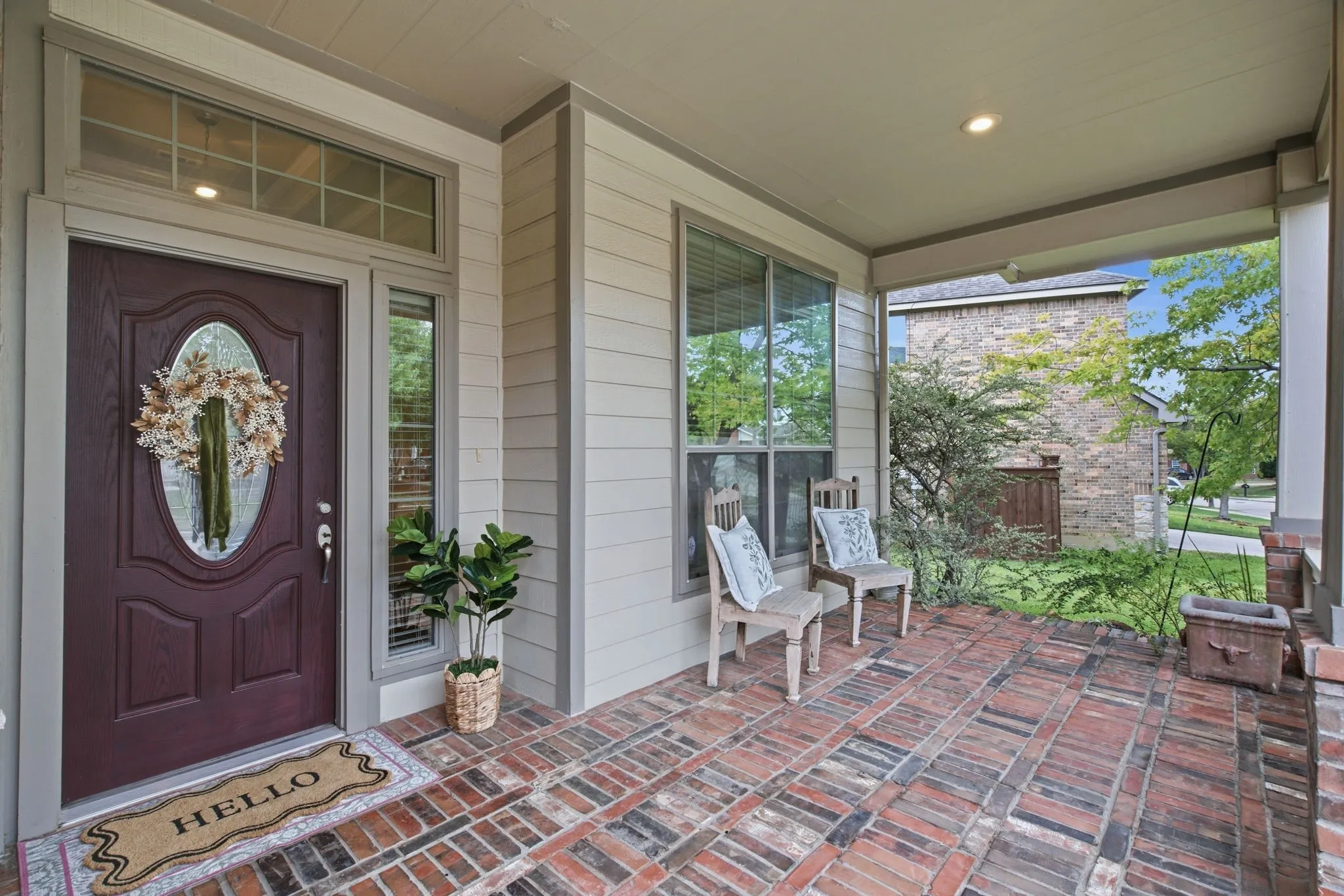 Welcoming covered front porch with brick flooring