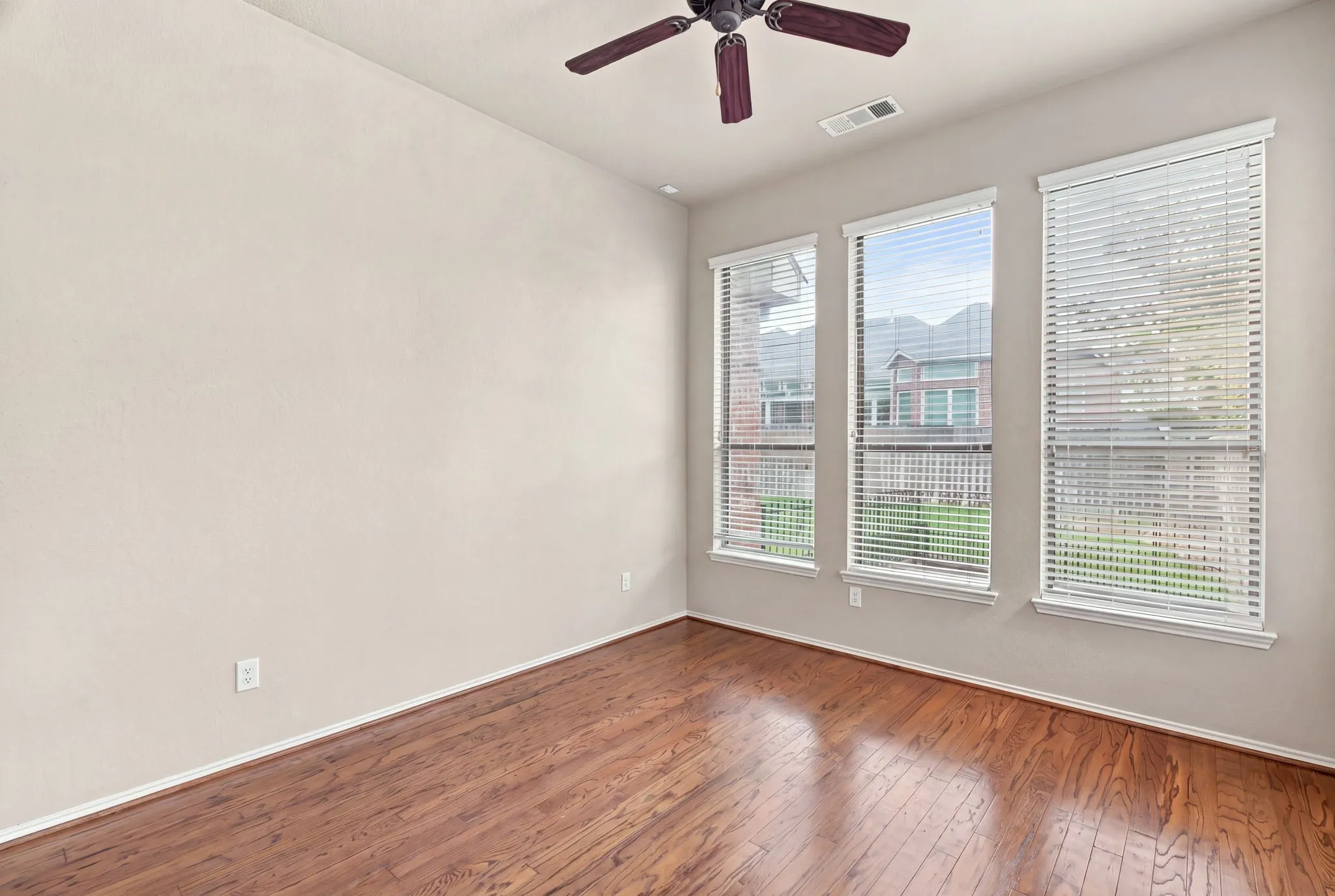 Study with hardwoods, two walls of windows! and a double sided fireplace