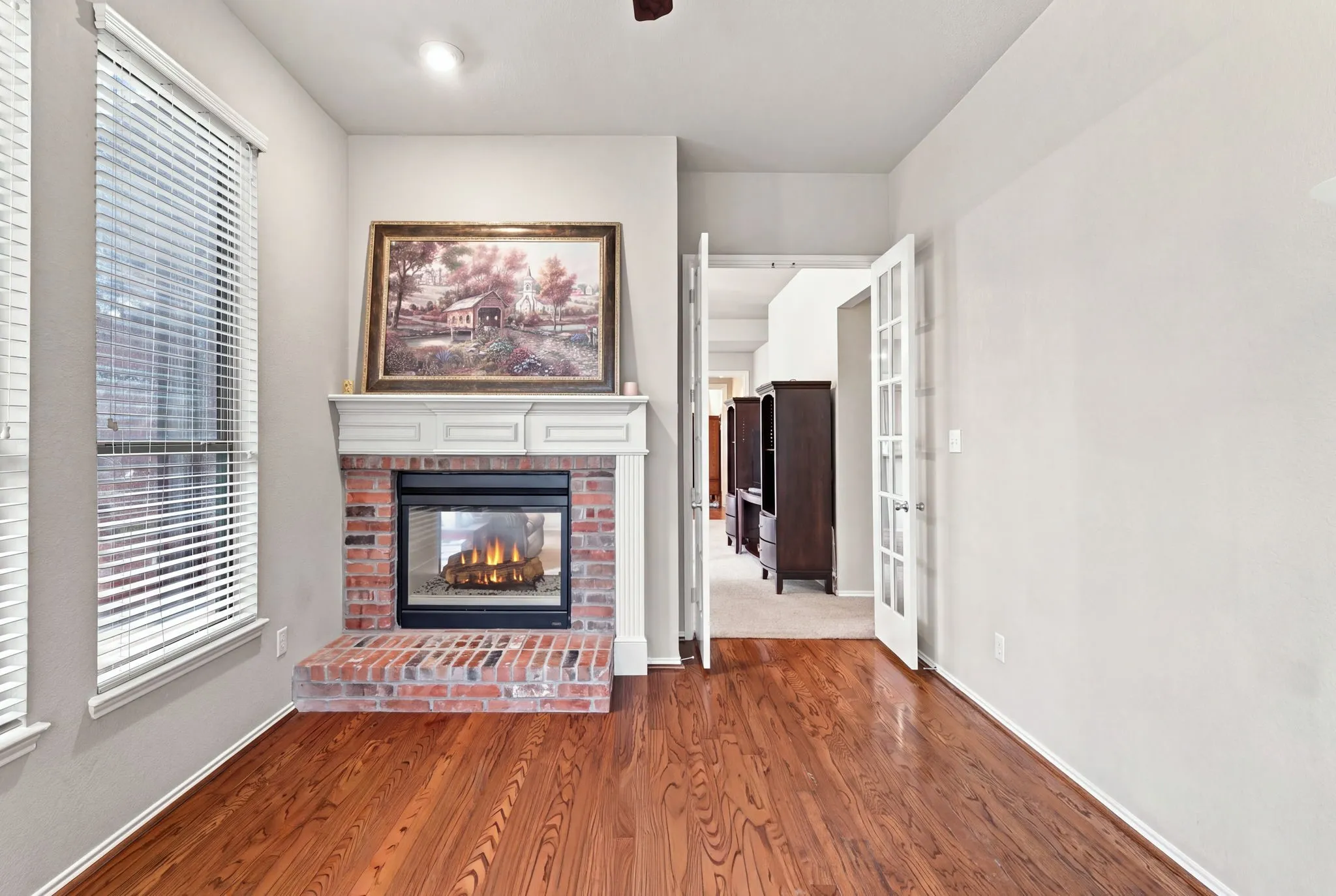 Very nice study with hardwood flooring and a double sided fireplace to enjoy a cozy work space or reading nook.