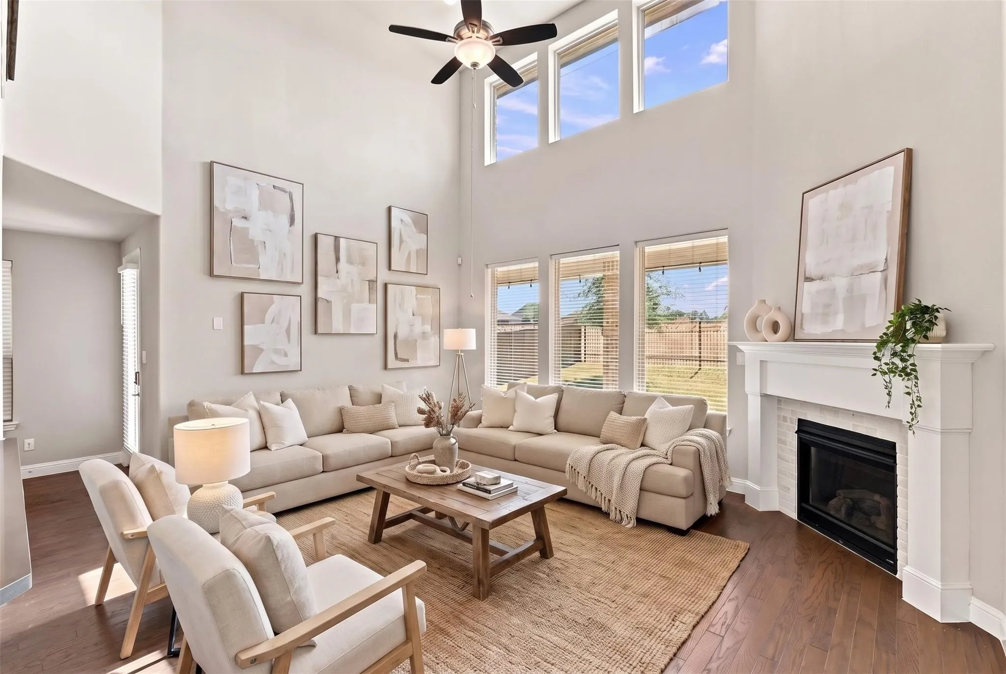 Soaring vaulted ceilings and abundant natural light define this expansive living room, anchored by gas fireplace. (Virtually staged photo)