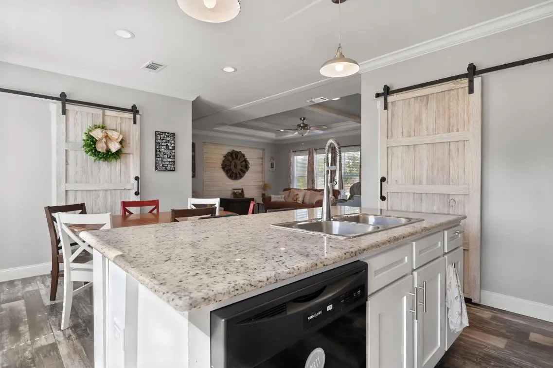 Kitchen island with granite countertop and undermount double sink