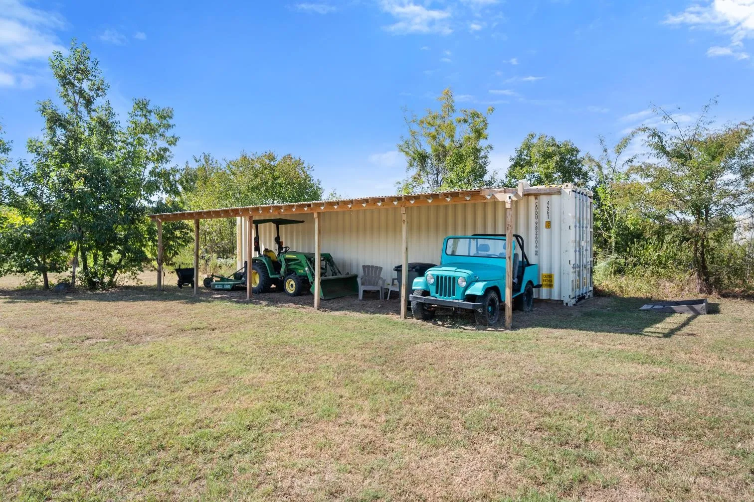 Covered storage structure with a corrugated metal roof and wood support posts