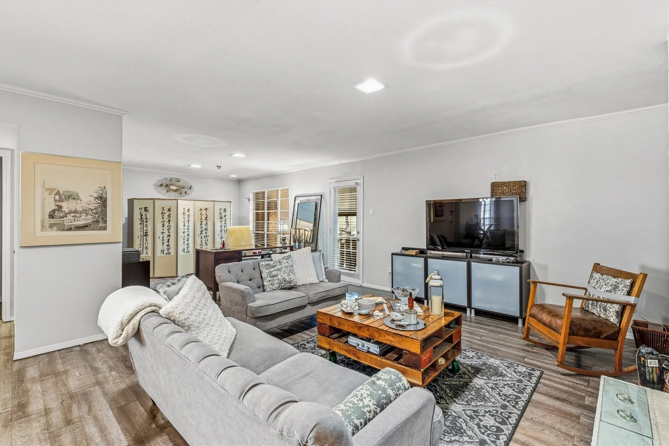 Wood-finish flooring throughout, complemented by light-colored walls and recessed lighting