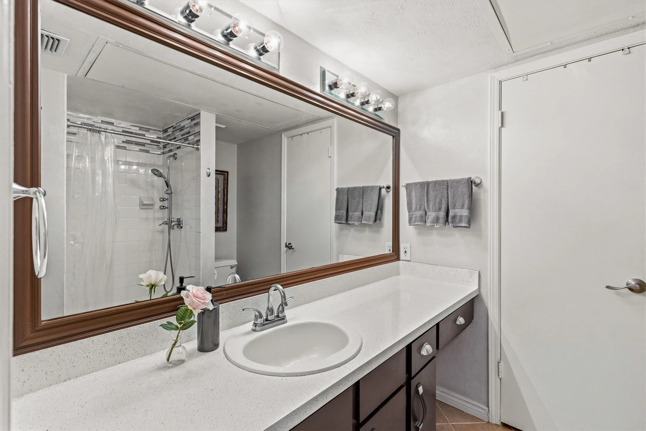 Expansive vanity with a white countertop and integrated sink