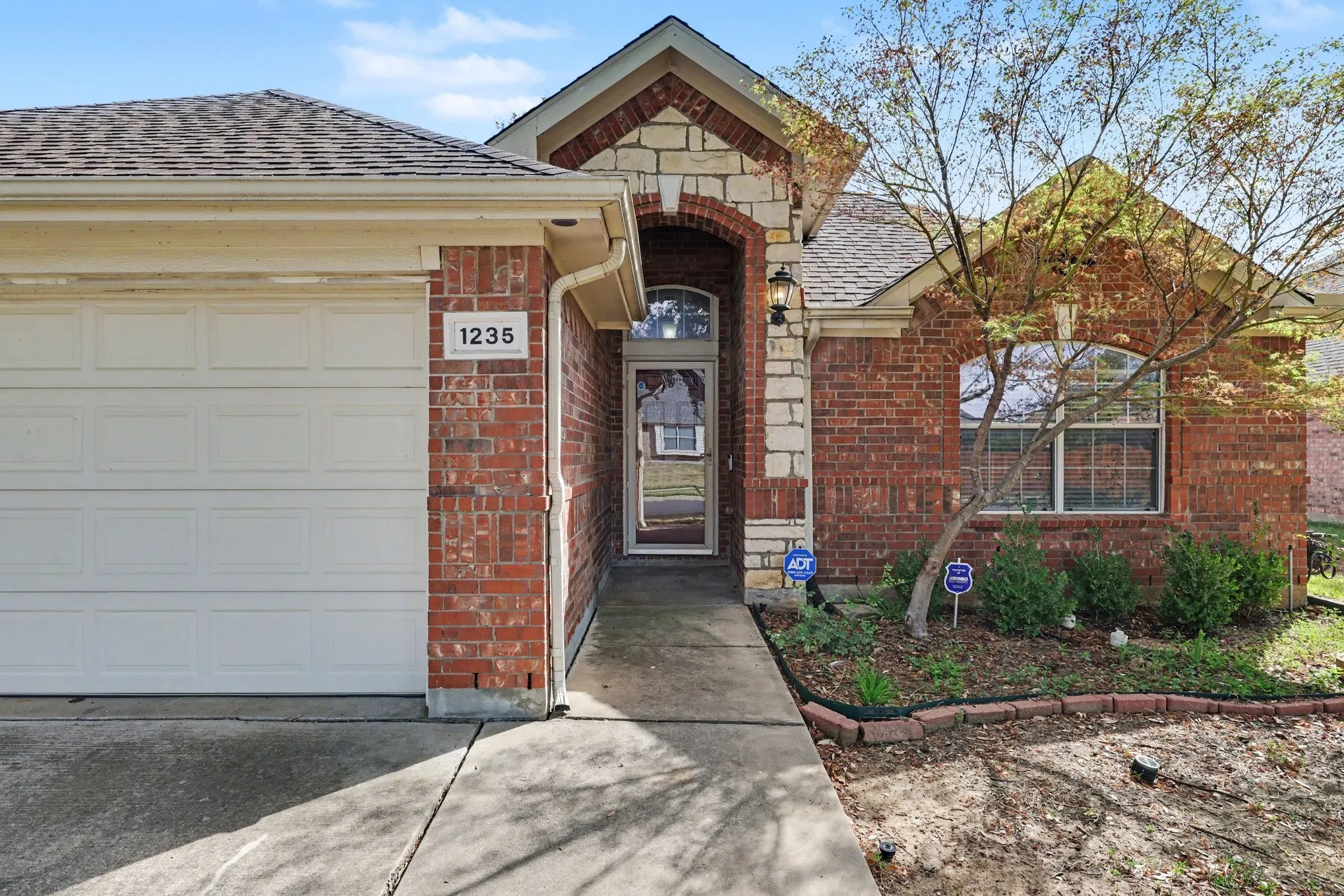 Brick and stone veneer exterior with a gabled roof