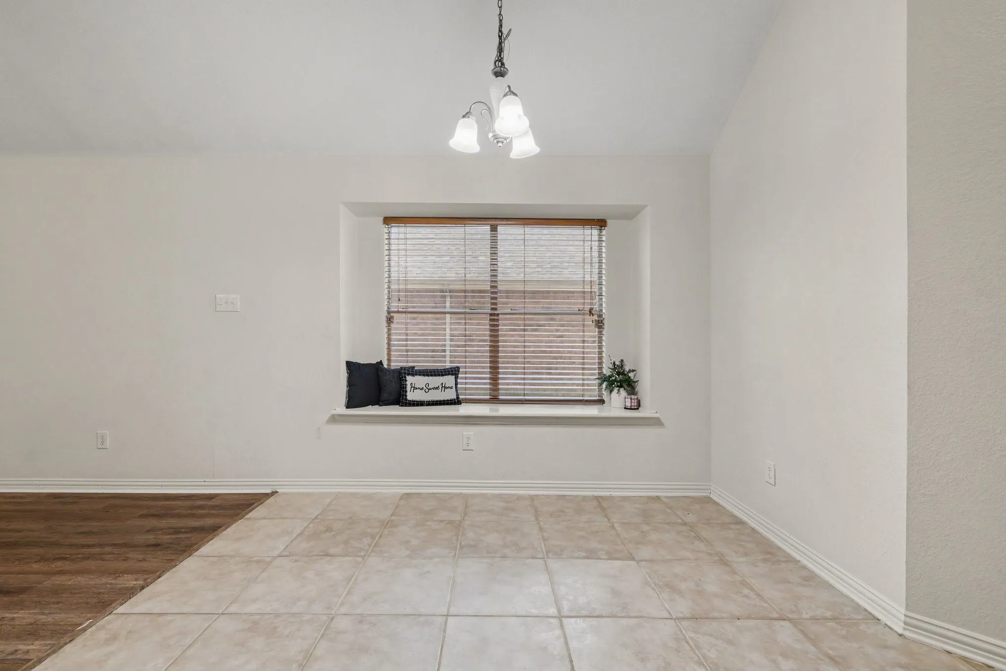 Recessed window alcove with wood-finish blinds, and a built-in window seat