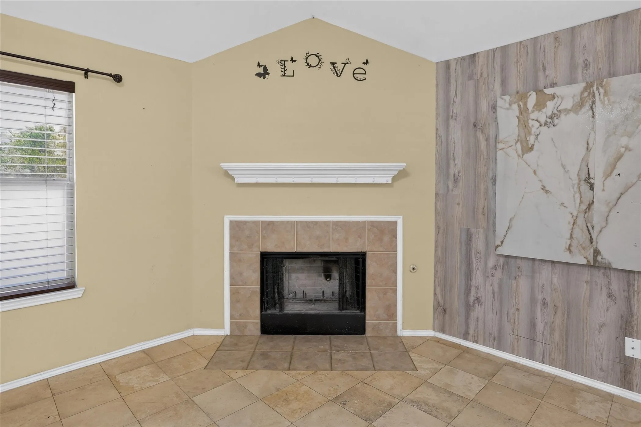 Angled fireplace featuring a tiled surround and a white mantelpiece