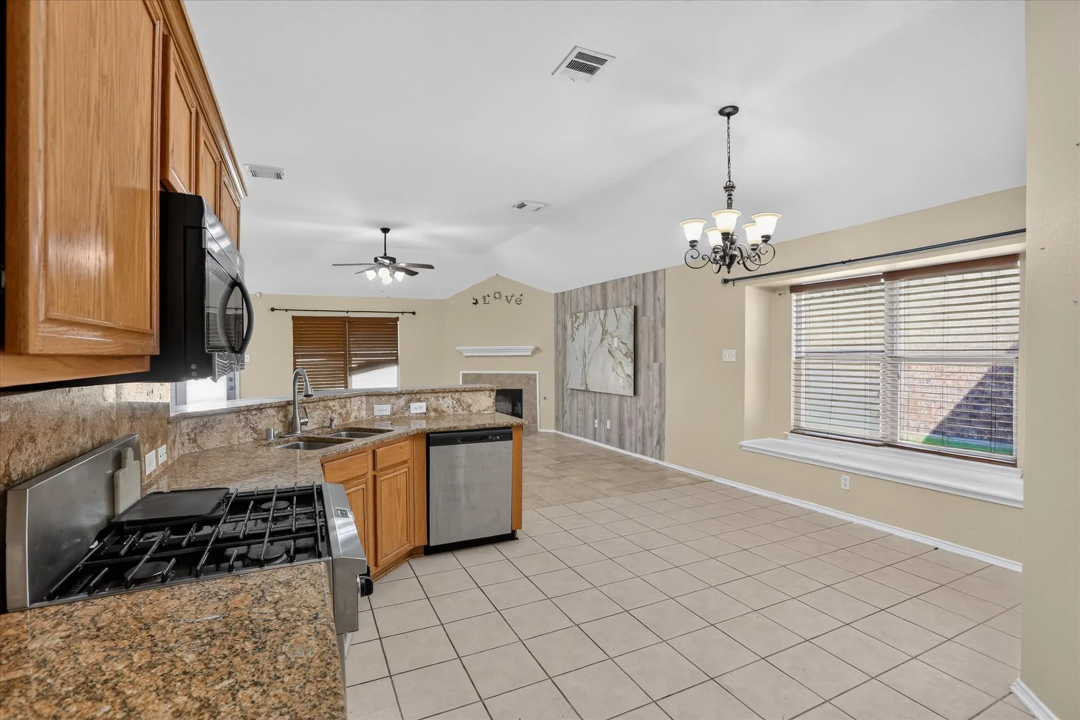 Kitchen featuring wood cabinetry, granite-style countertops, and stainless steel appliances
